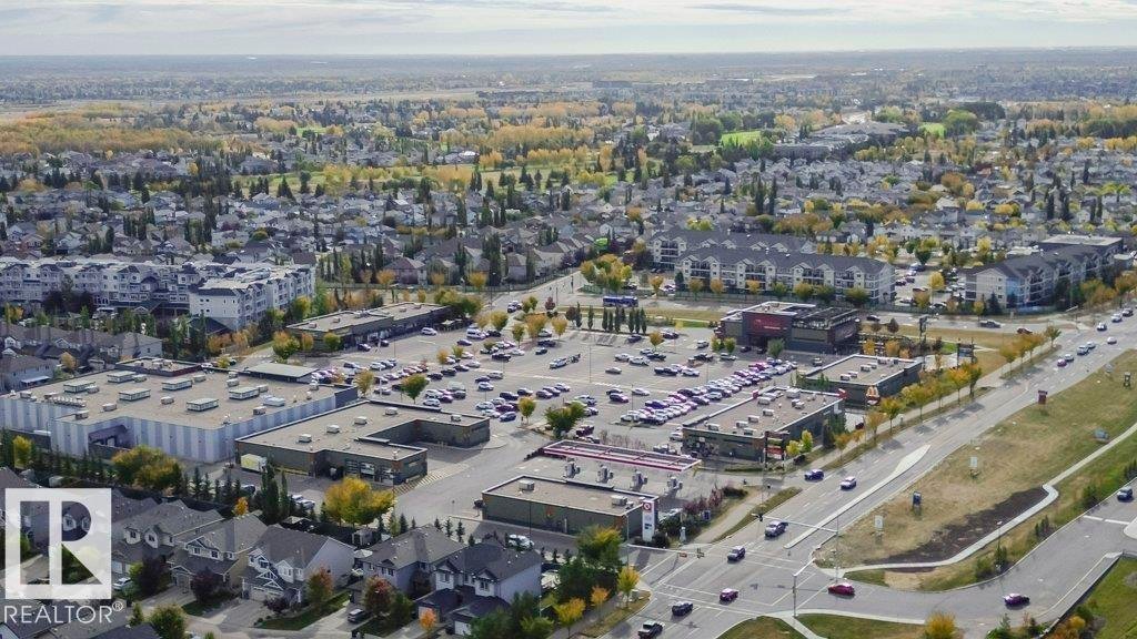 Aerial view of the community, showcasing residential properties, commercial buildings, and extensive green spaces - 320 Secord Boulevard, Edmonton, AB - Outdoor With View
