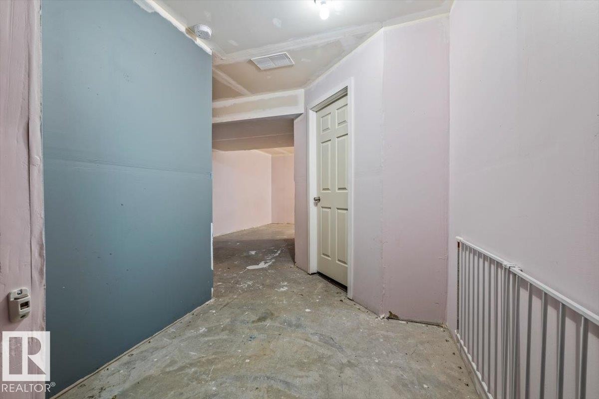 Partially finished basement with open space, furnace room, and one bathroom. - 17703 65 Street Nw, Edmonton, AB
