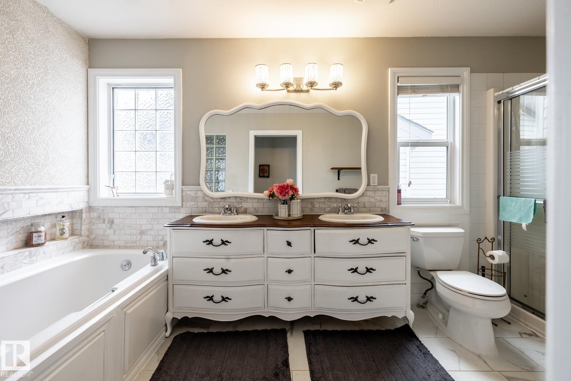 Bathroom featuring a double vanity with an ornate mirror, a built-in tub with a tile surround, a separate shower with a glass enclosure, and white tile flooring - 2036 Towne Centre Boulevard, Edmonton, AB - Indoor Photo Showing Bathroom