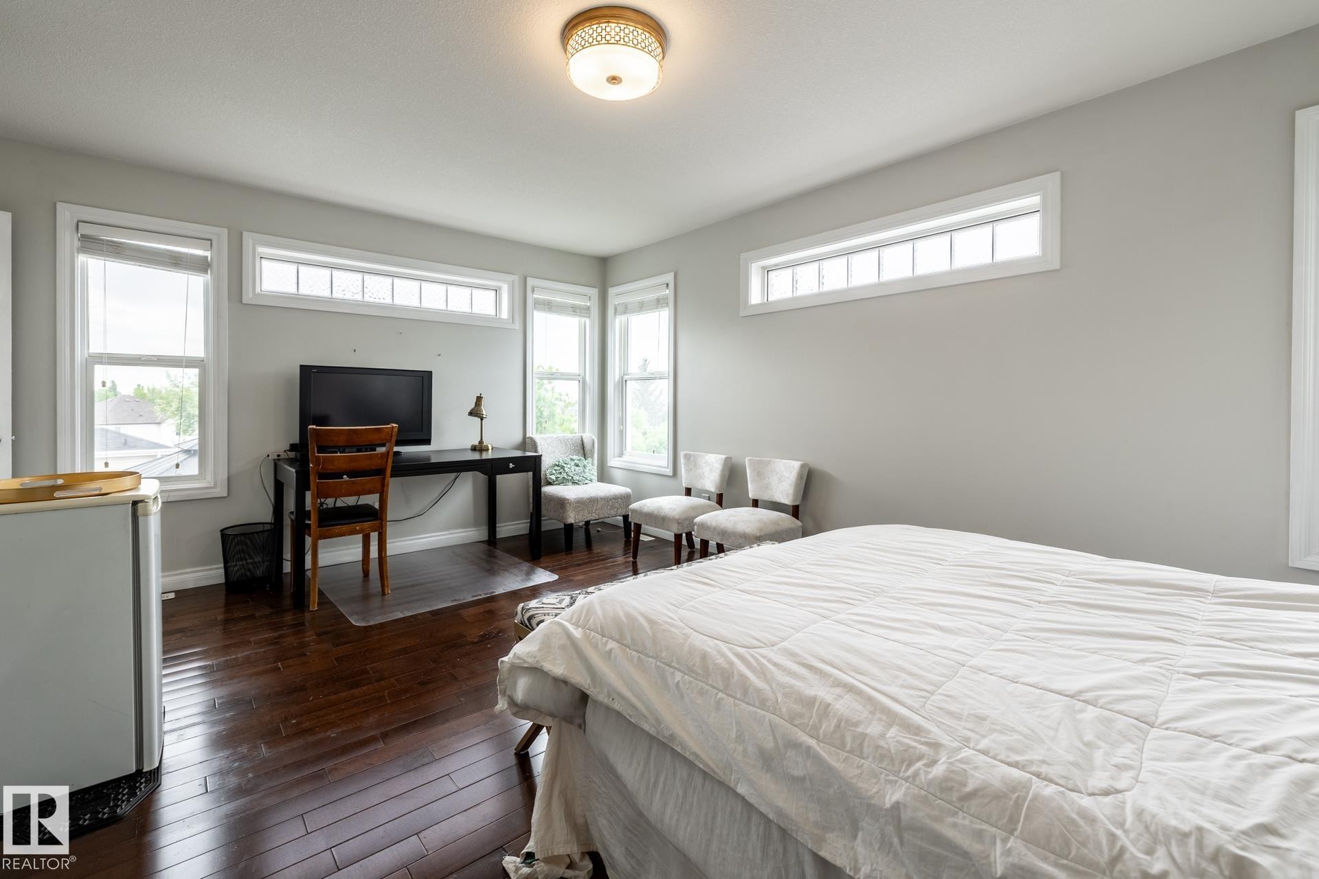 Spacious room featuring rich wood-finish flooring and light grey walls - 2036 Towne Centre Boulevard, Edmonton, AB - Indoor Photo Showing Bedroom