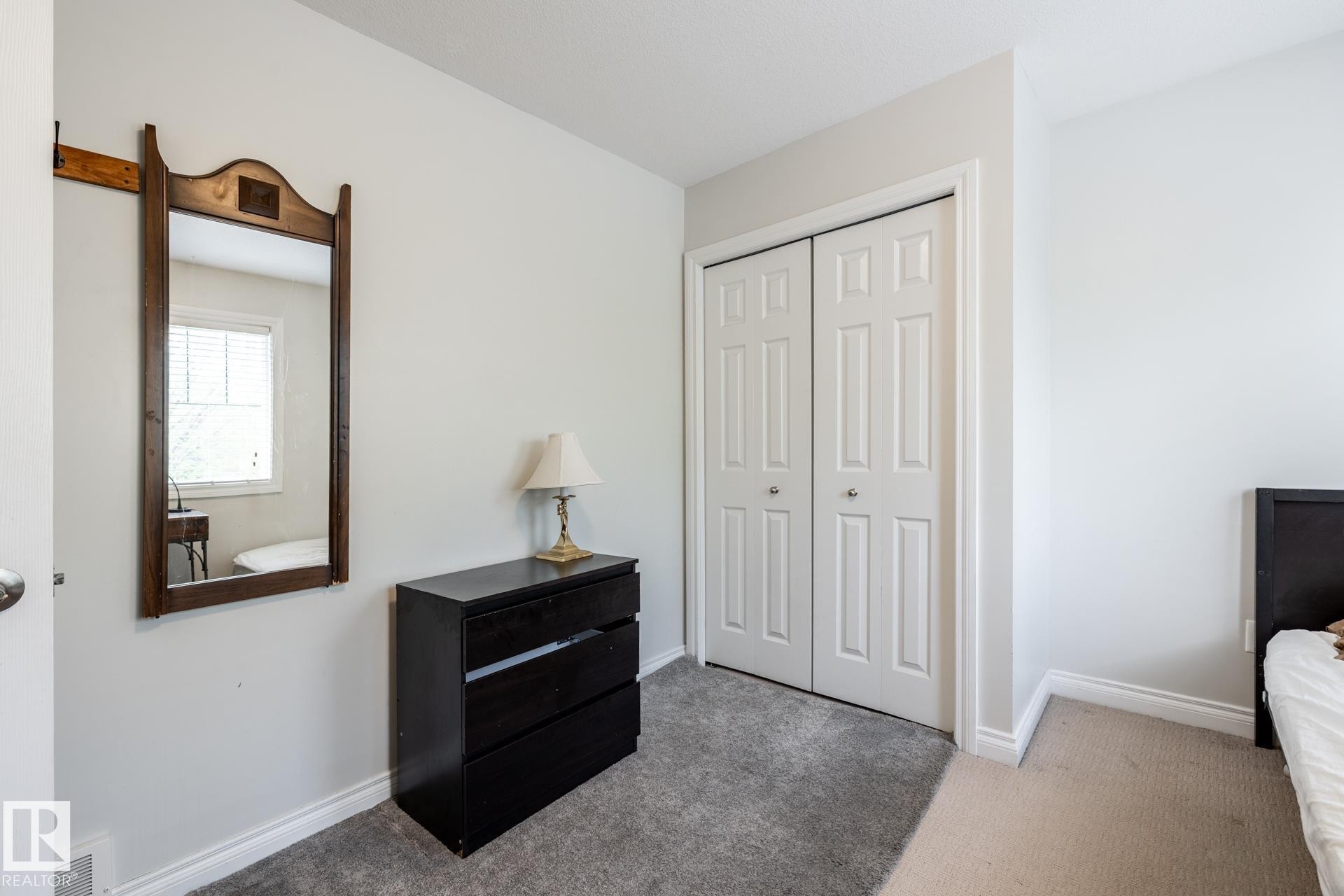 White paneled bi-fold closet doors feature prominent hardware - 2036 Towne Centre Boulevard, Edmonton, AB - Indoor