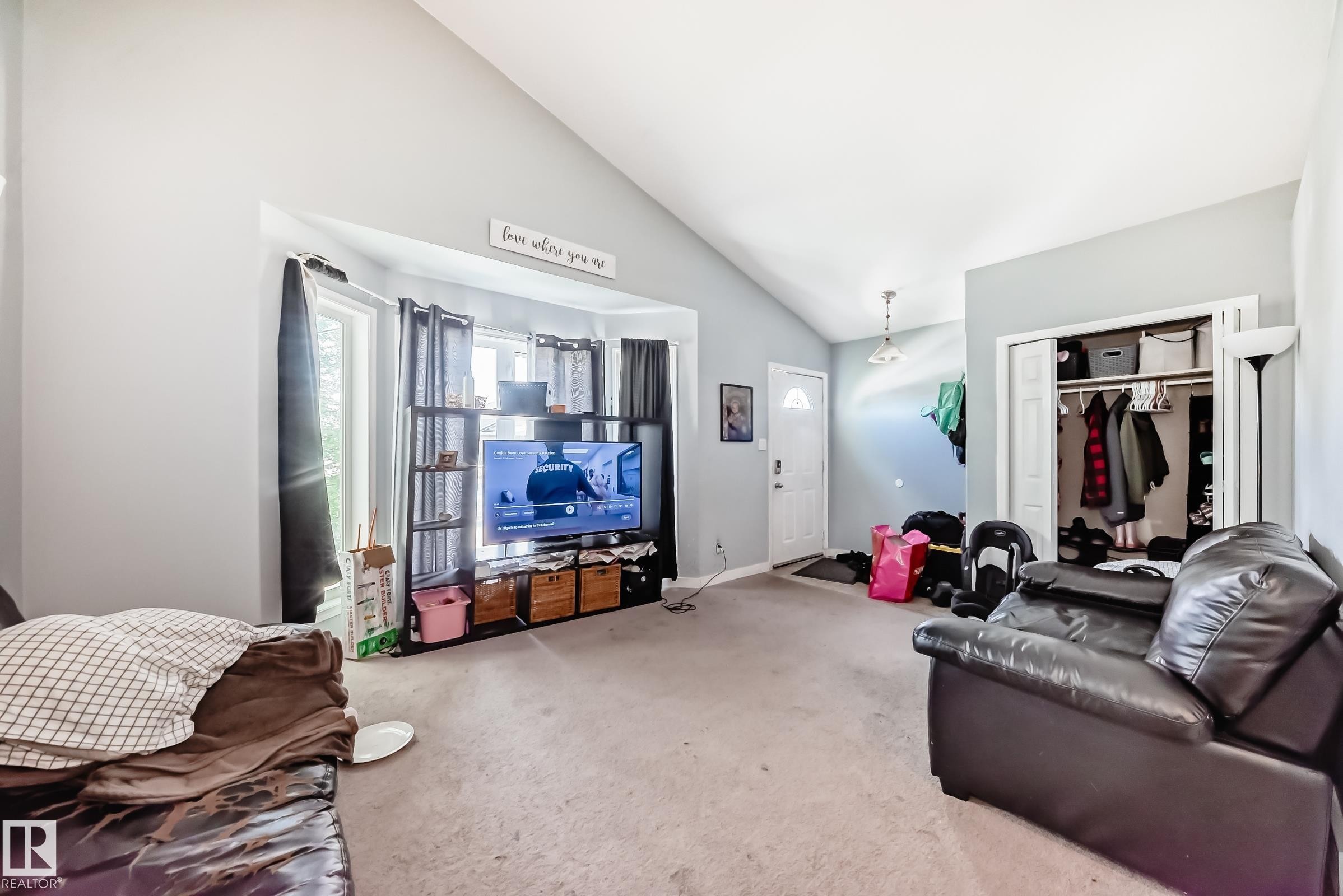 Living area featuring a vaulted ceiling and light gray wall paint - 10017 153 Street, Edmonton, AB - Indoor