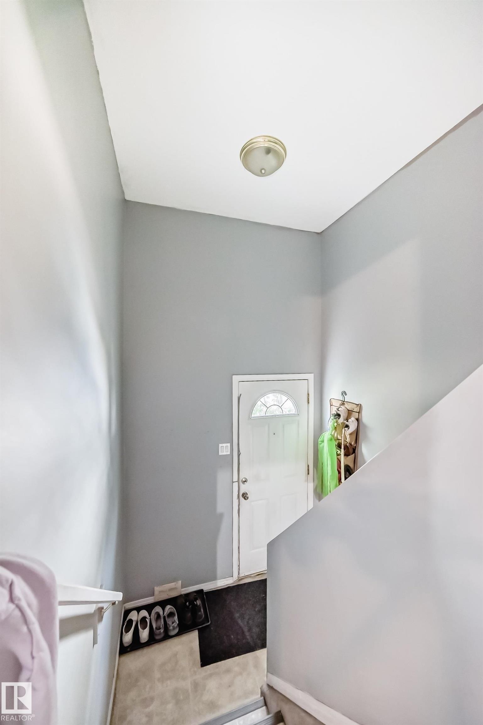 Entryway featuring light gray walls, a white front door with an arched window, and a flush-mount ceiling light fixture - 10017 153 Street, Edmonton, AB - Indoor