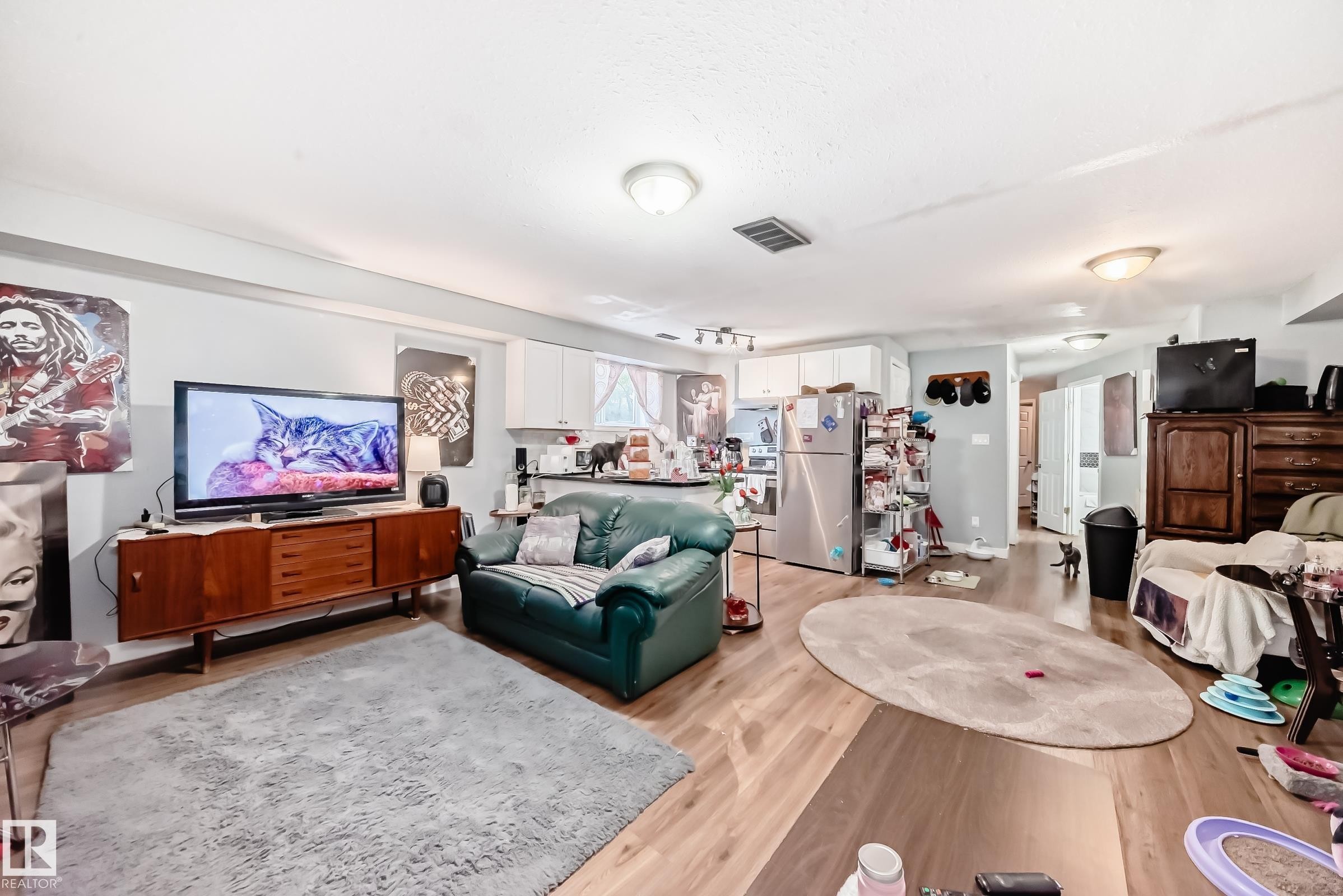 Open-concept living space with wood-finish flooring, recessed lighting, and a neutral wall palette - 10017 153 Street, Edmonton, AB - Indoor Photo Showing Living Room