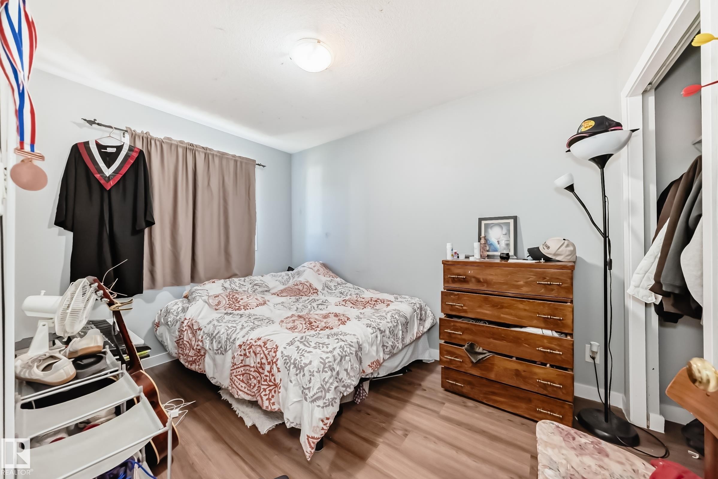 Bedroom featuring wood-finish flooring, light grey walls, and a recessed ceiling light - 10017 153 Street, Edmonton, AB - Indoor Photo Showing Bedroom