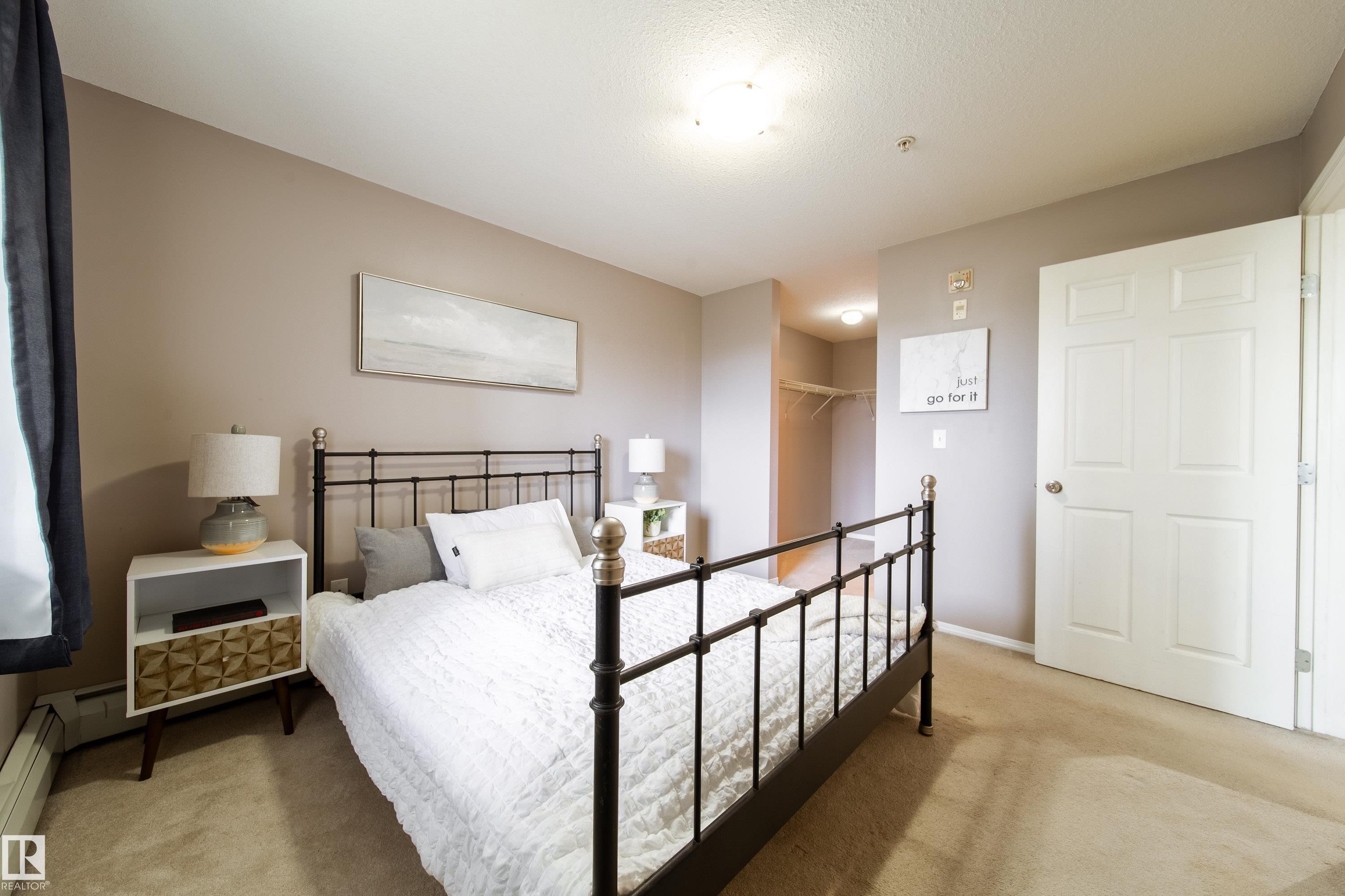 Carpeted room with neutral wall tones and a white four-panel door - 115 4309 33 Street, Stony Plain, AB