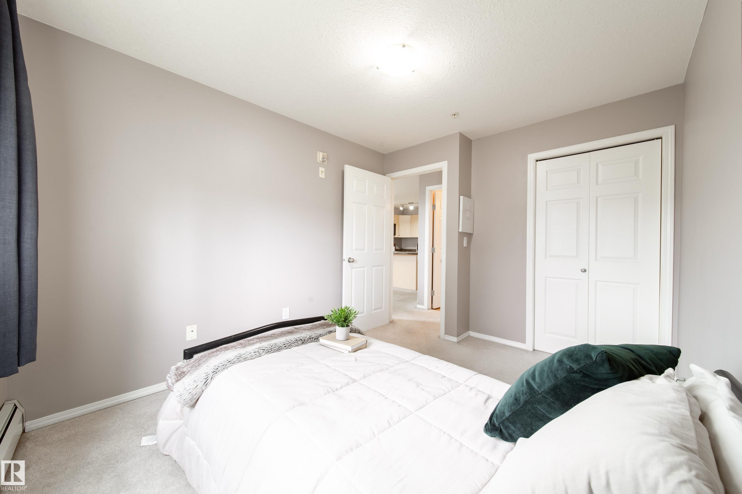 Neutral-toned room featuring light gray walls and coordinating carpet flooring - 115 4309 33 Street, Stony Plain, AB