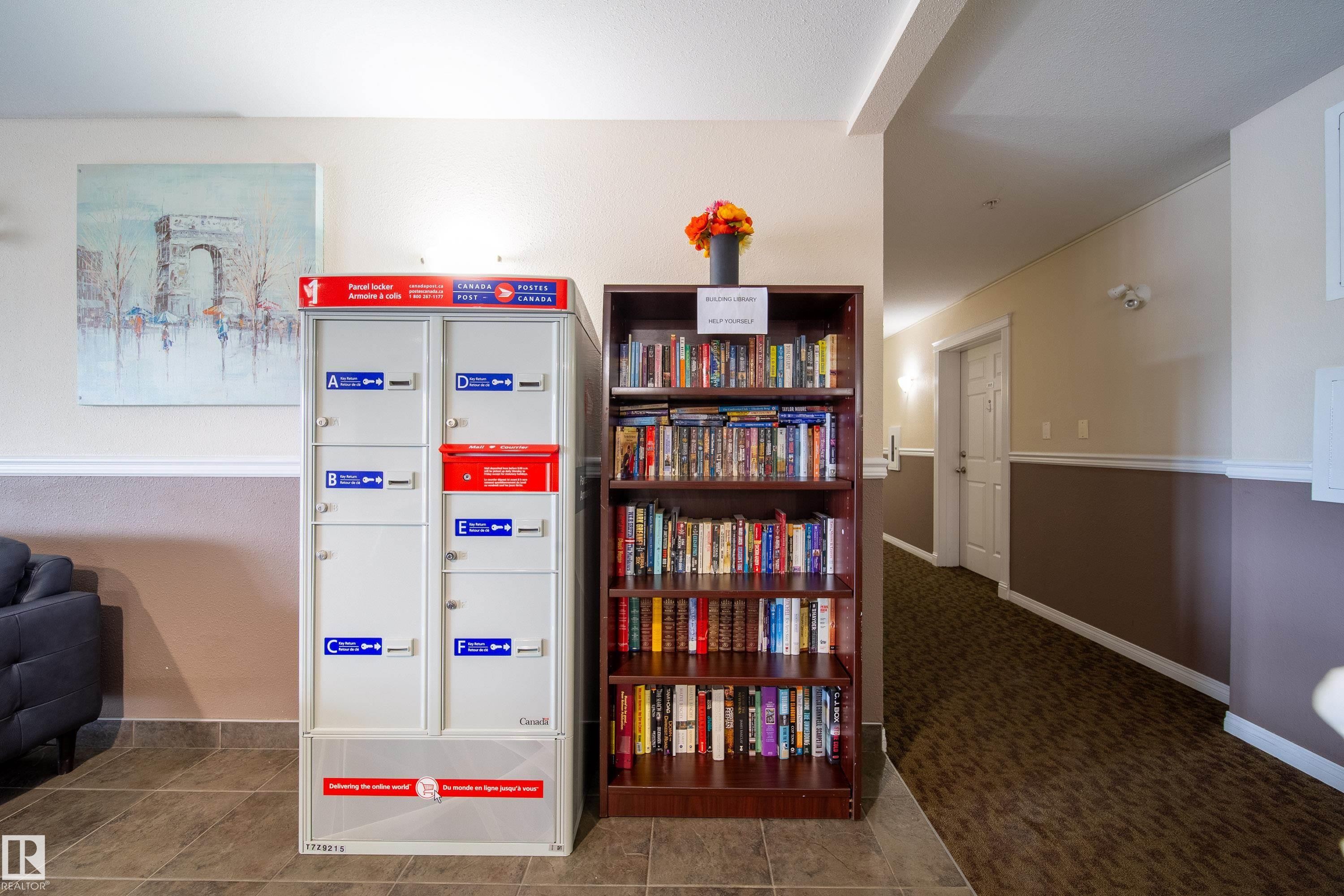 Hallway featuring a built-in mail center and a communal bookshelf - 115 4309 33 Street, Stony Plain, AB