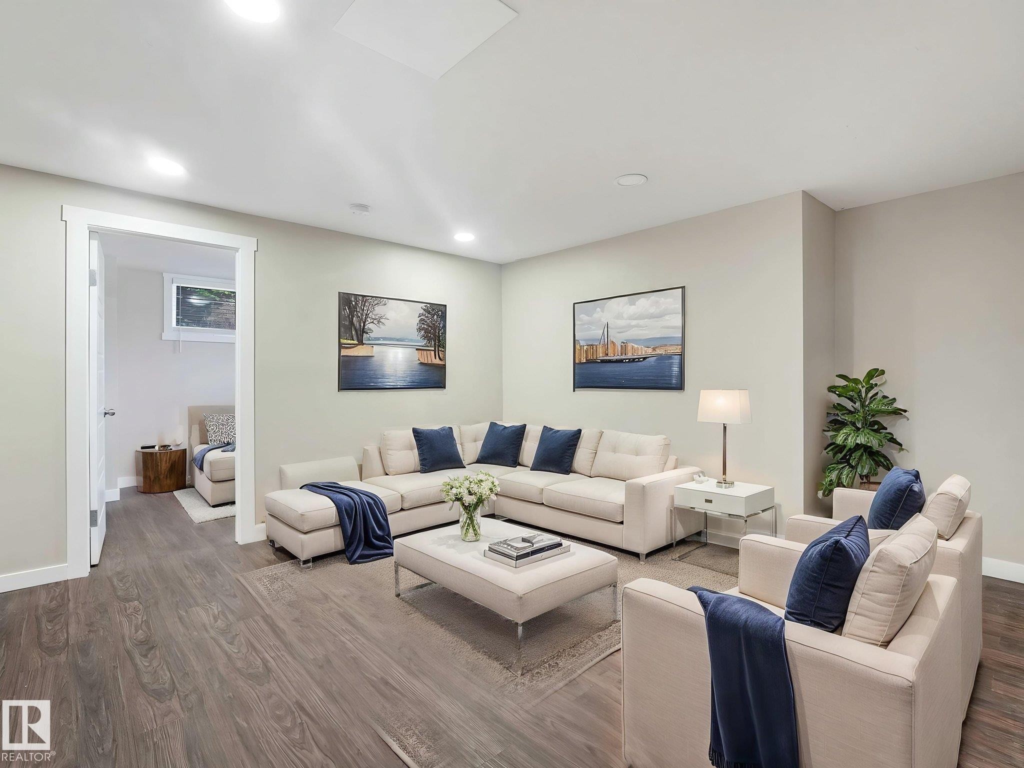 Spacious living area featuring wood-finish flooring, recessed lighting, and light-toned wall finishes - 12241 54 Street Nw, Edmonton, AB - Indoor Photo Showing Living Room