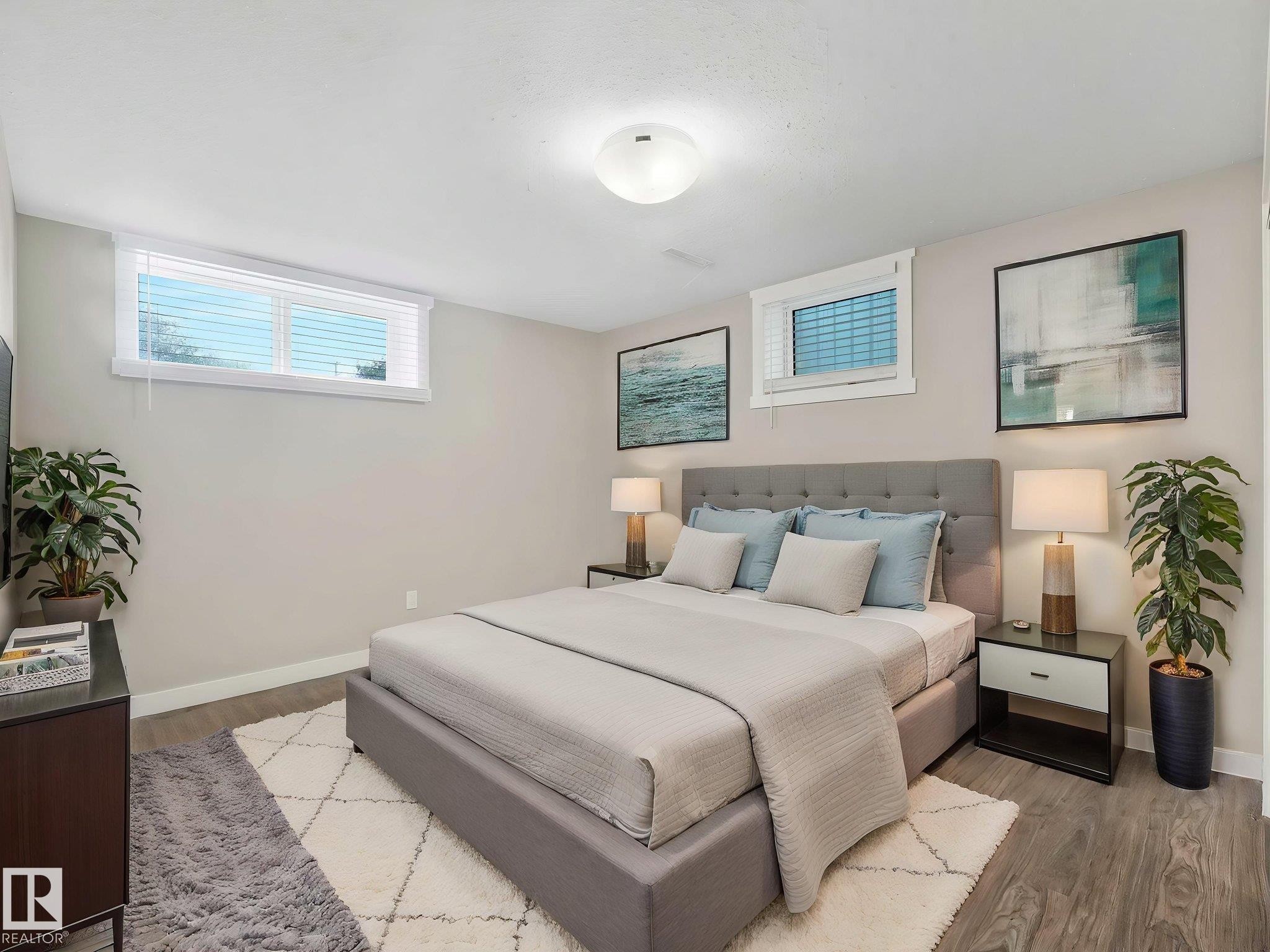 Spacious room featuring light gray walls and wood-finish flooring - 12241 54 Street Nw, Edmonton, AB - Indoor Photo Showing Bedroom