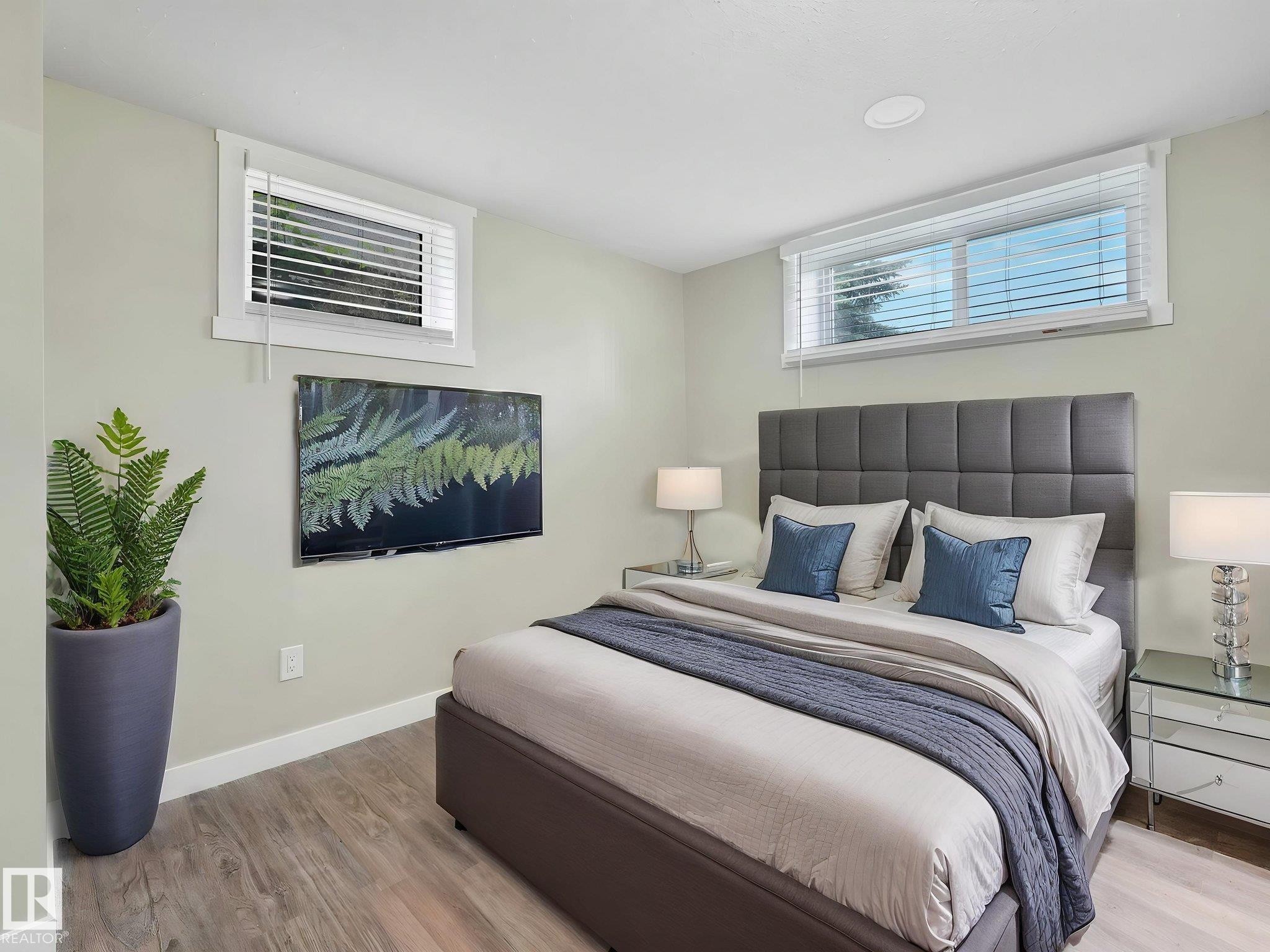 Spacious room featuring wood-finish flooring and light-toned walls - 12241 54 Street Nw, Edmonton, AB - Indoor Photo Showing Bedroom