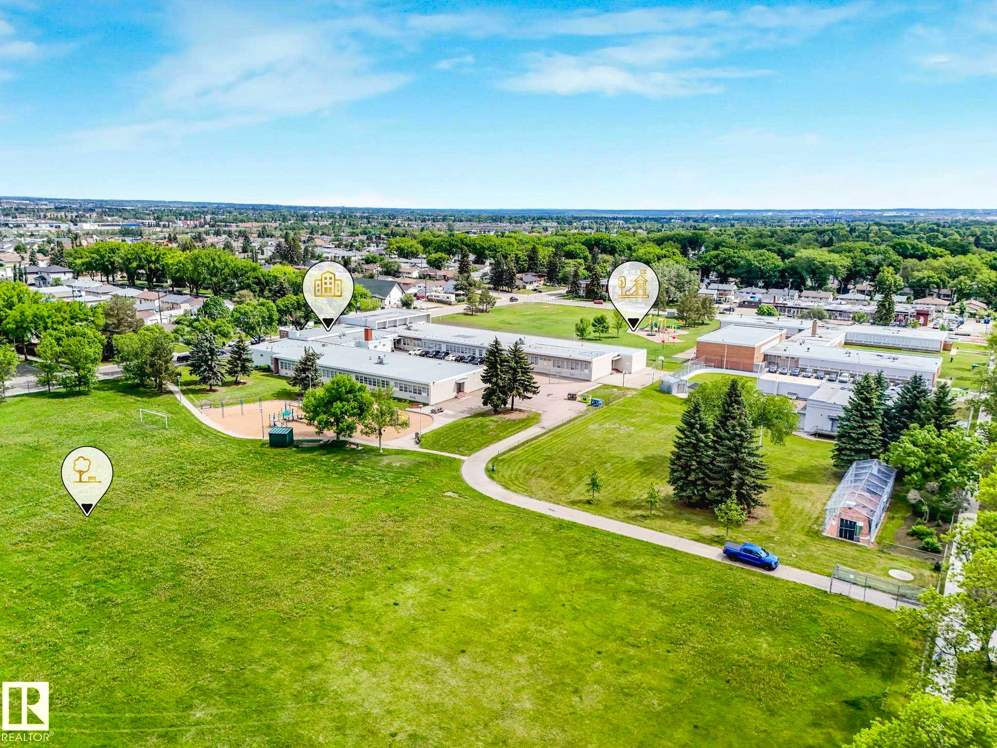 Expansive green space with manicured lawns and mature trees - 12241 54 Street Nw, Edmonton, AB - Outdoor With View