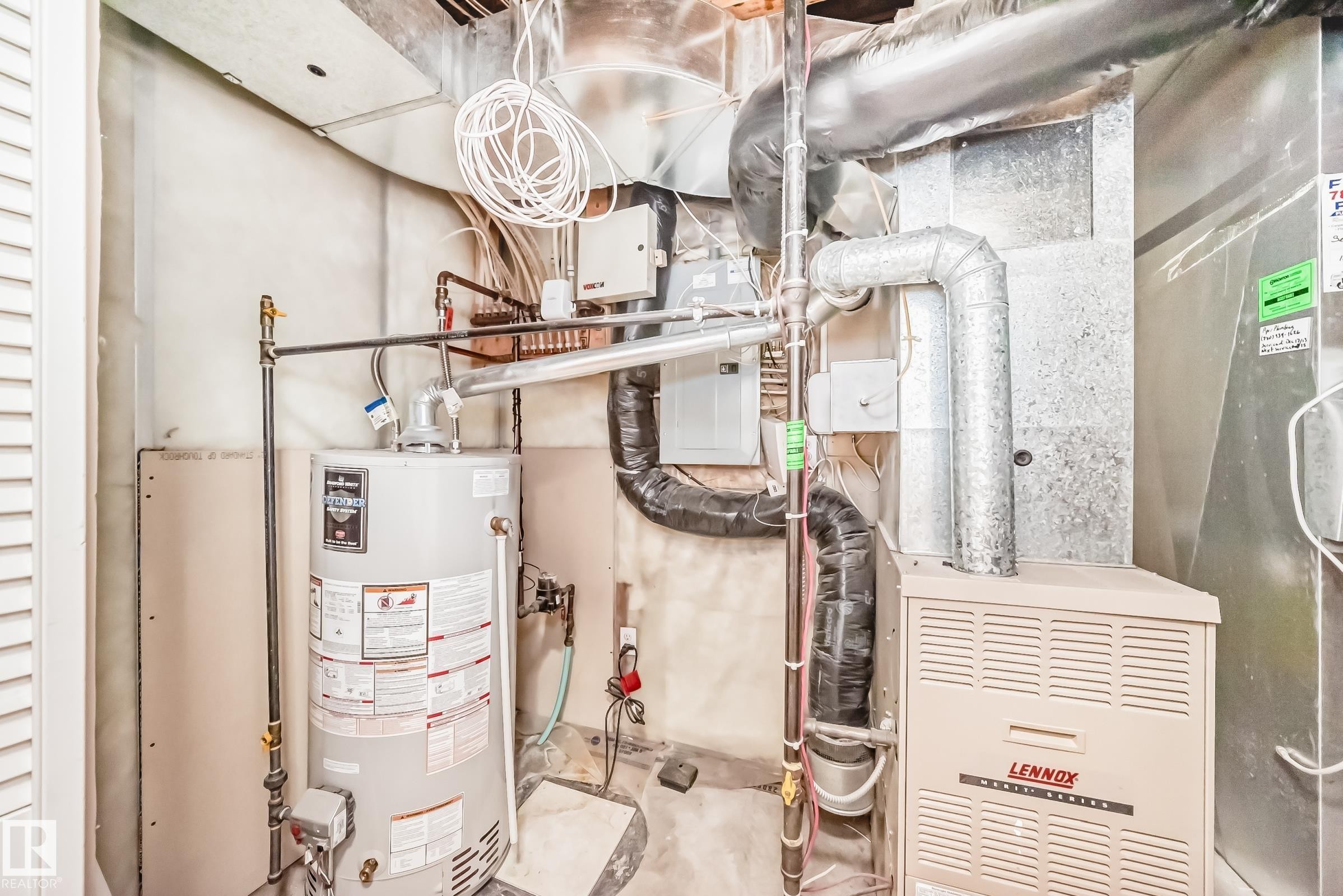 Utility area featuring a water heater and a Lennox furnace unit - 3711 22A St, Edmonton, AB
