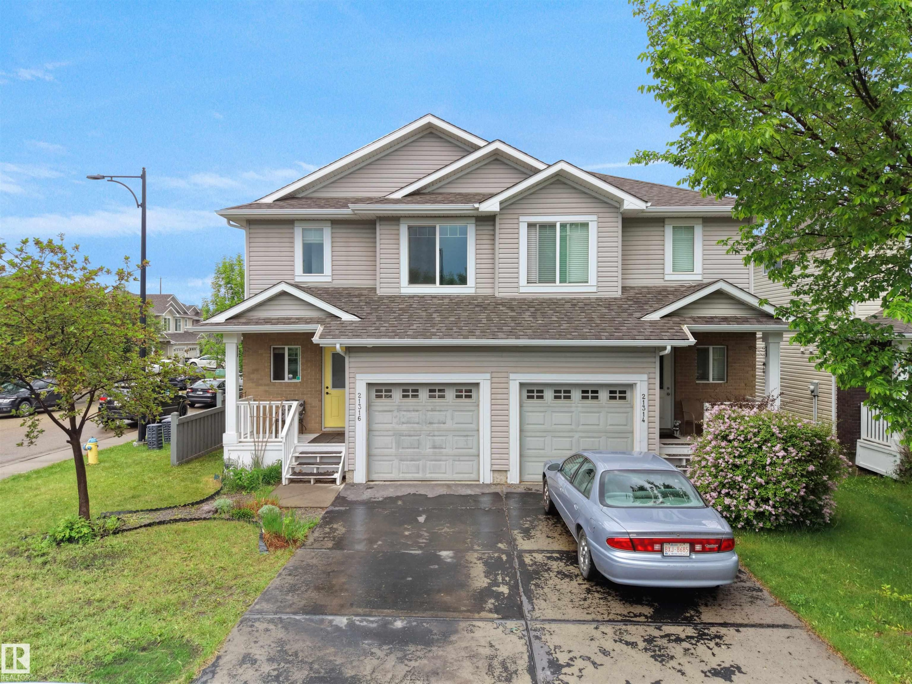 Two-story duplex featuring neutral siding and white trim - 21316 45A Avenue Nw, Edmonton, AB