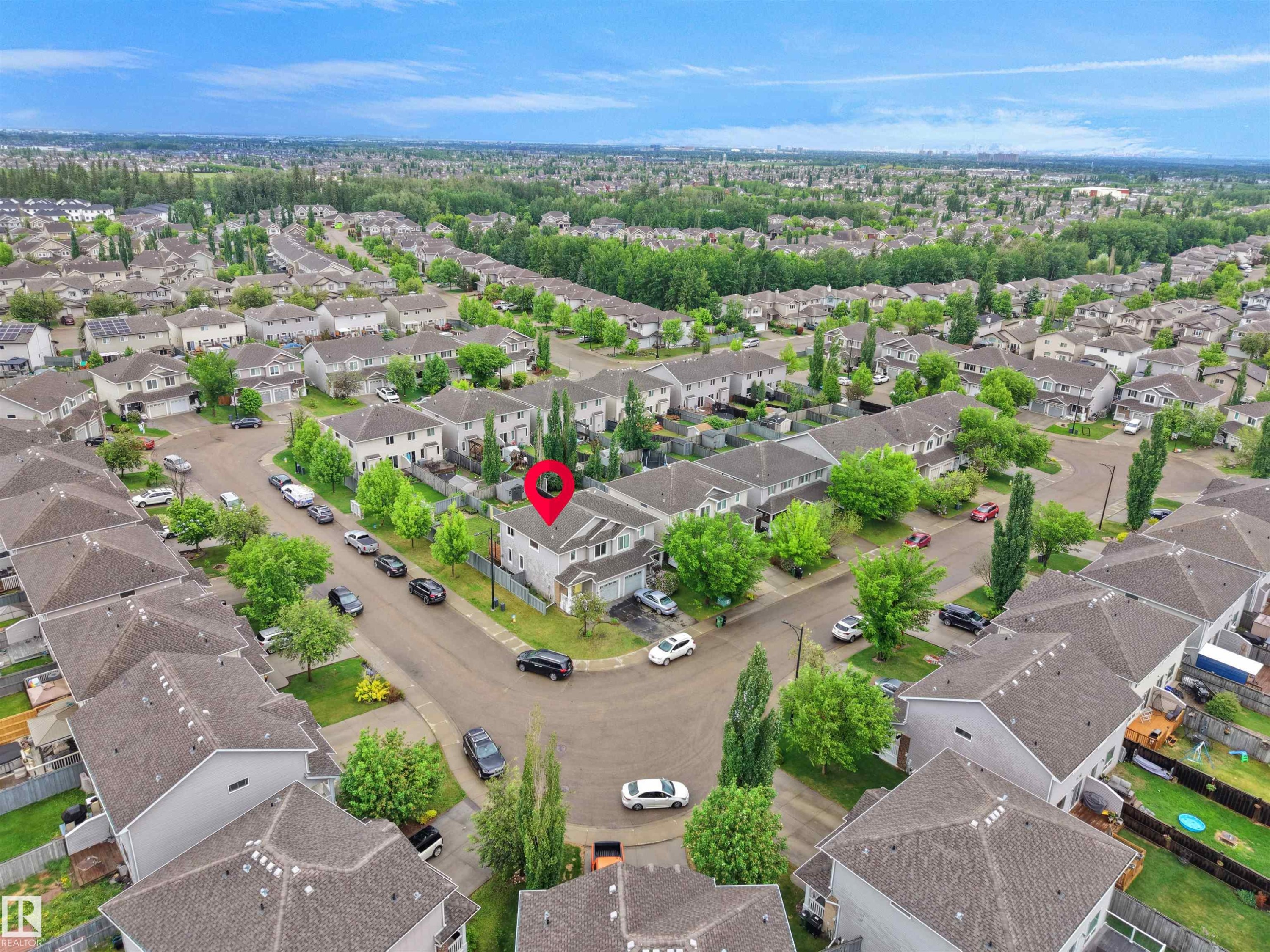 Aerial perspective of a residential neighborhood featuring detached and attached properties with asphalt shingle roofs - 21316 45A Avenue Nw, Edmonton, AB