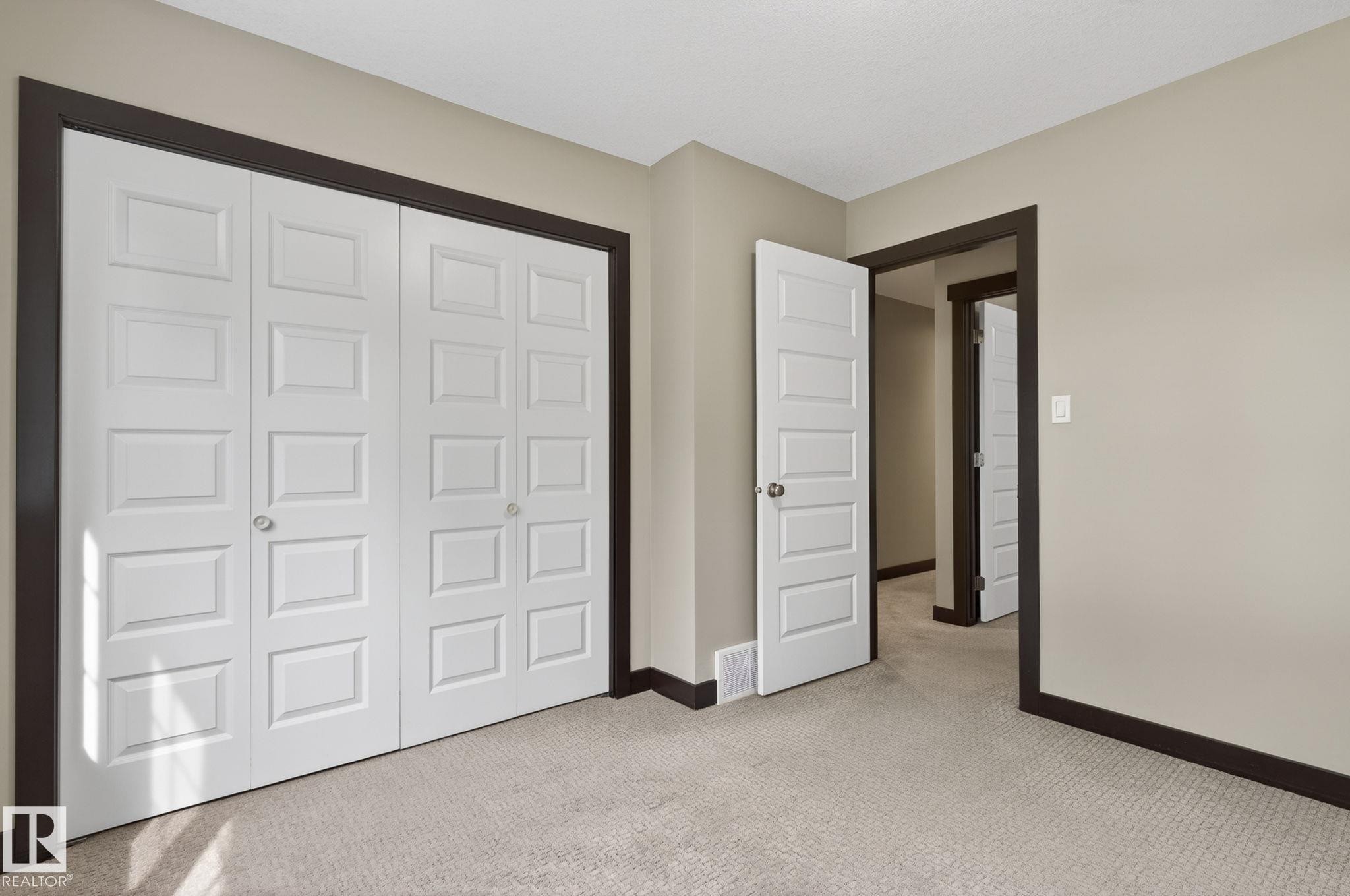 Light beige walls contrasting with dark trim and white paneled doors - 8506 80 Avenue, Edmonton, AB
