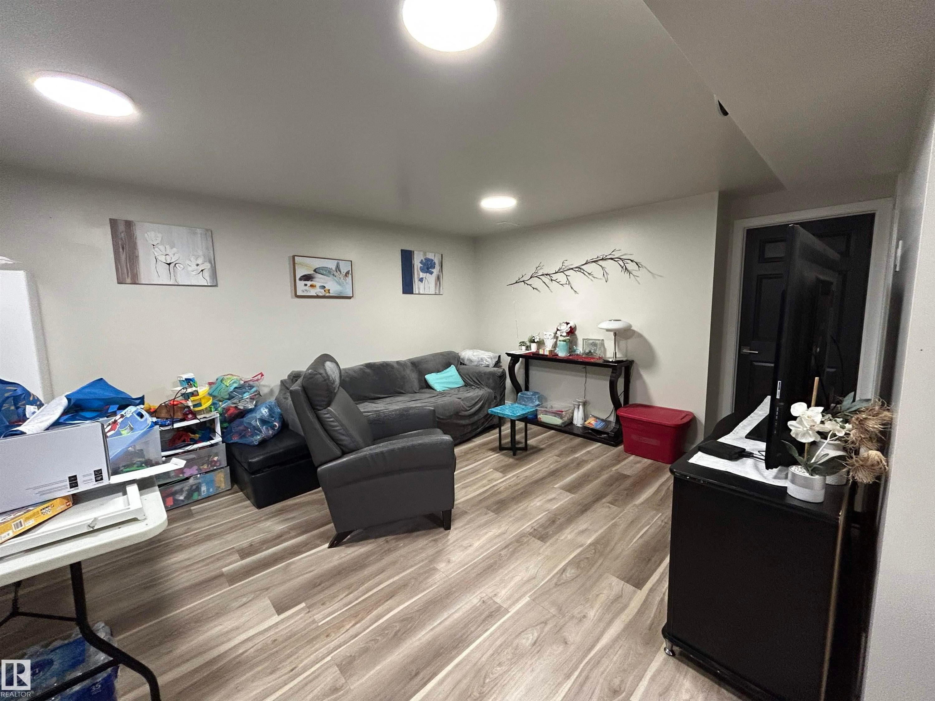 Finished space featuring recessed ceiling lighting, light-toned walls, and wood-finish flooring - 10924 30 Street, Edmonton, AB