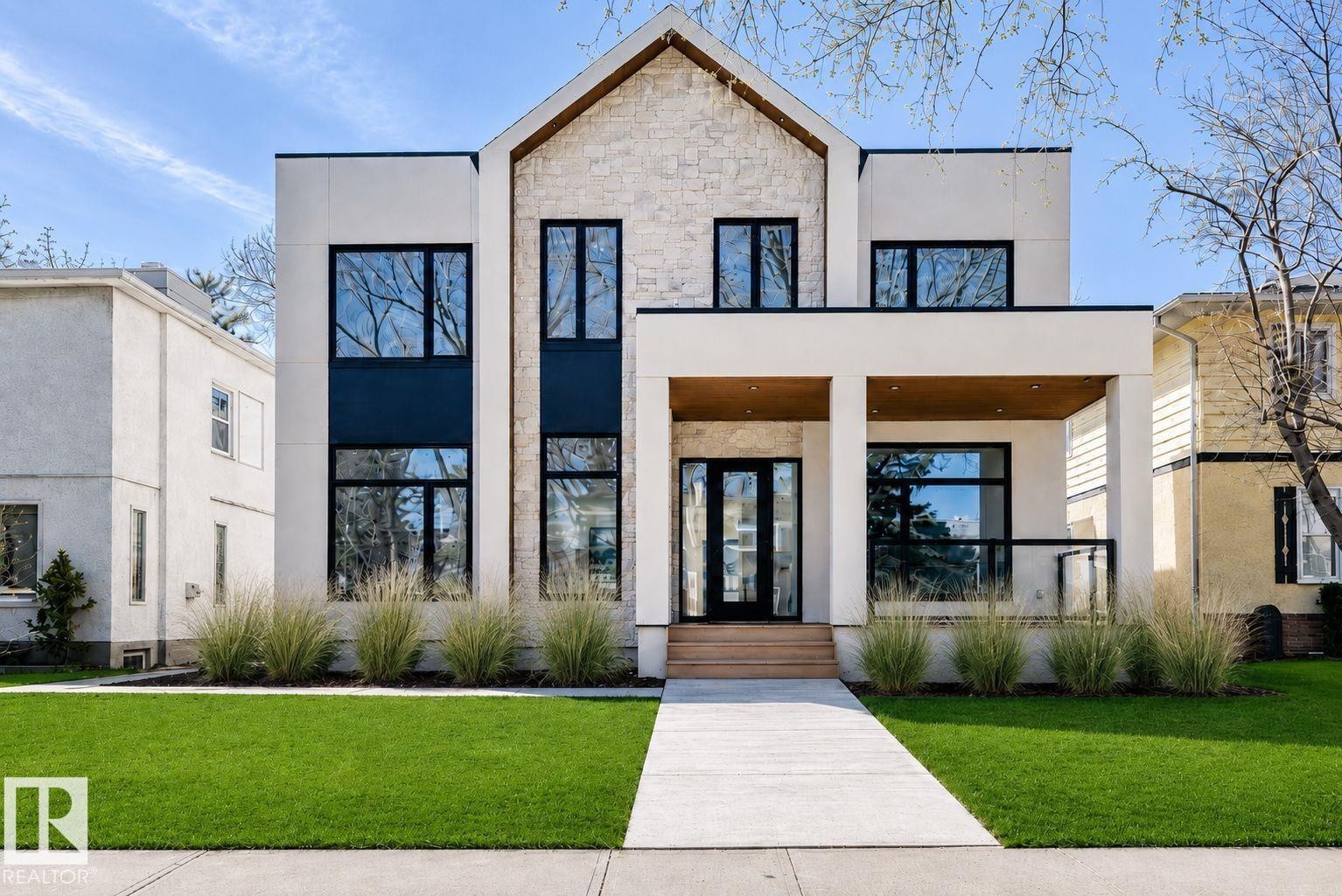Contemporary facade featuring white stucco, stone accents, and black-framed windows - 10514 134 Street, Edmonton, AB