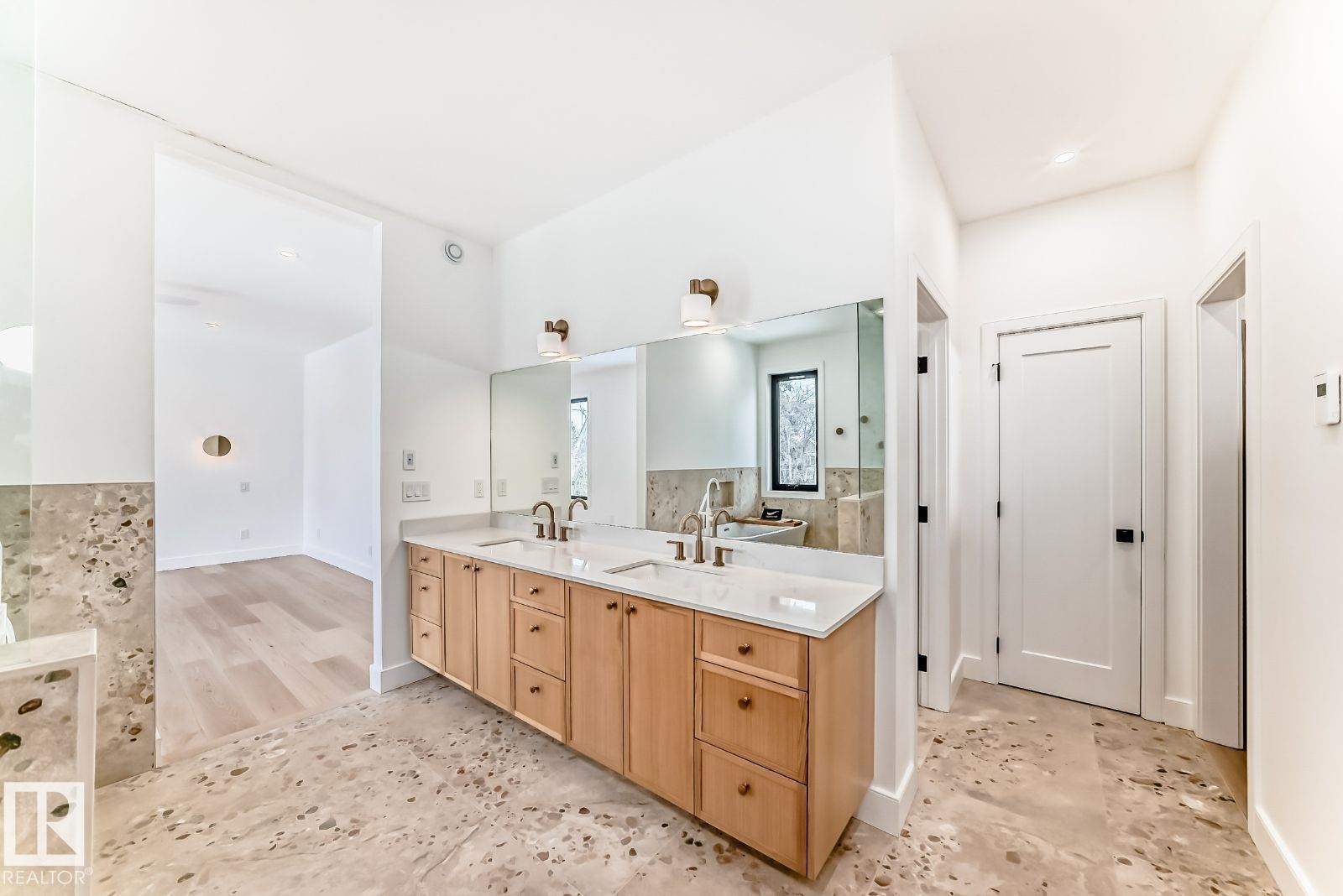 Dual sink vanity with light wood cabinetry and light stone countertops - 10514 134 Street, Edmonton, AB