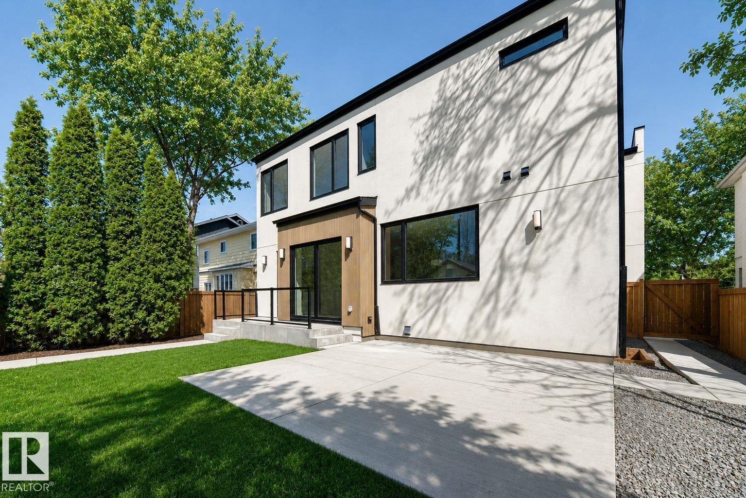 Contemporary white stucco exterior with black trim windows - 10514 134 Street, Edmonton, AB