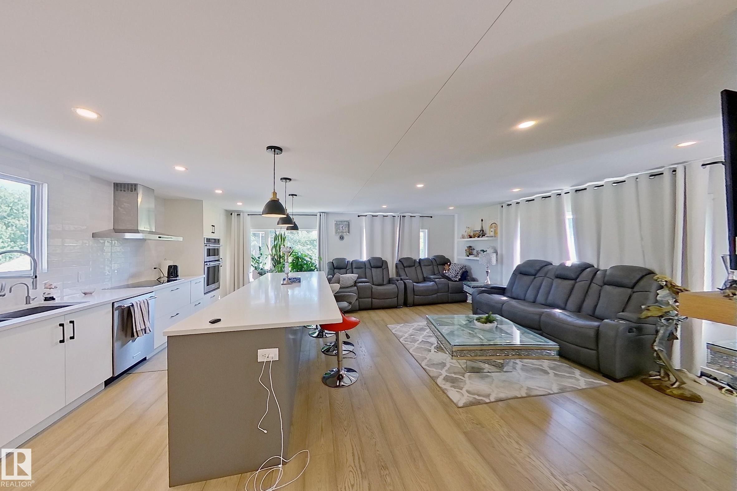 Open-concept living space with wood-finish flooring throughout - 3054 28 Avenue, Edmonton, AB