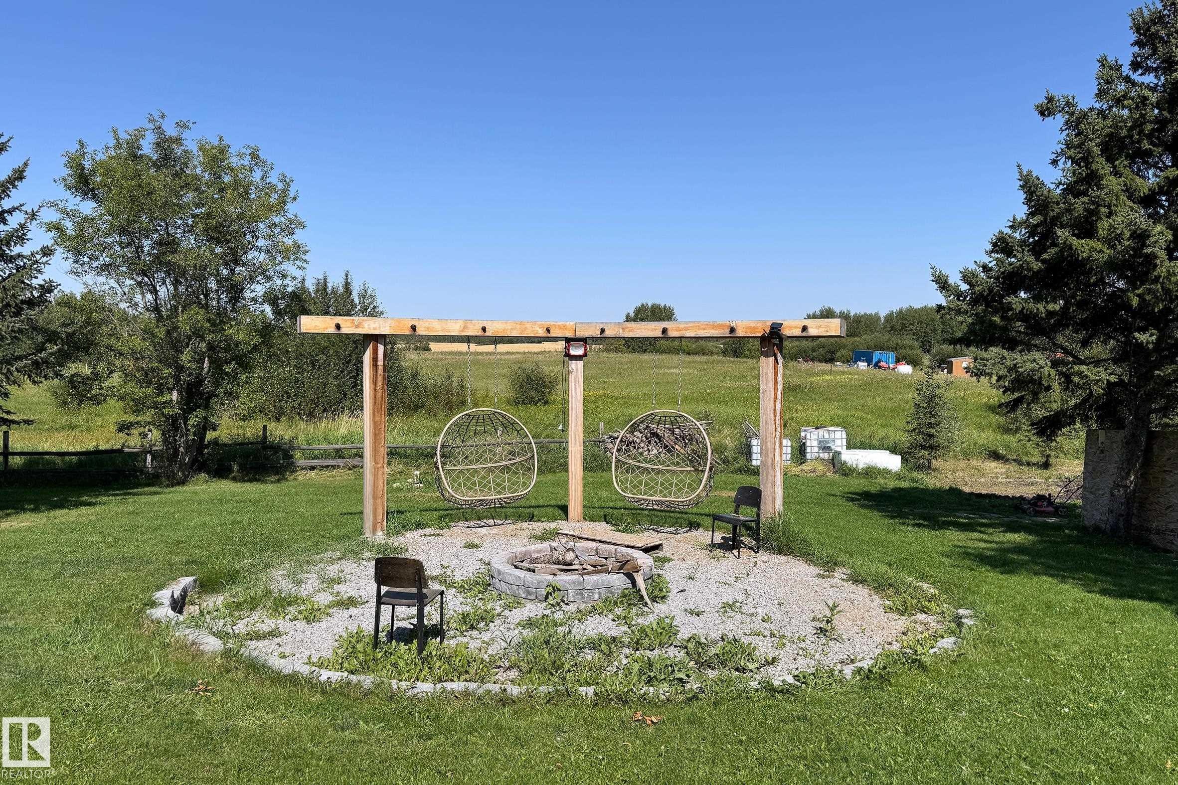 Outdoor gathering area featuring a gravel base and a built-in fire pit - 3054 28 Avenue, Edmonton, AB