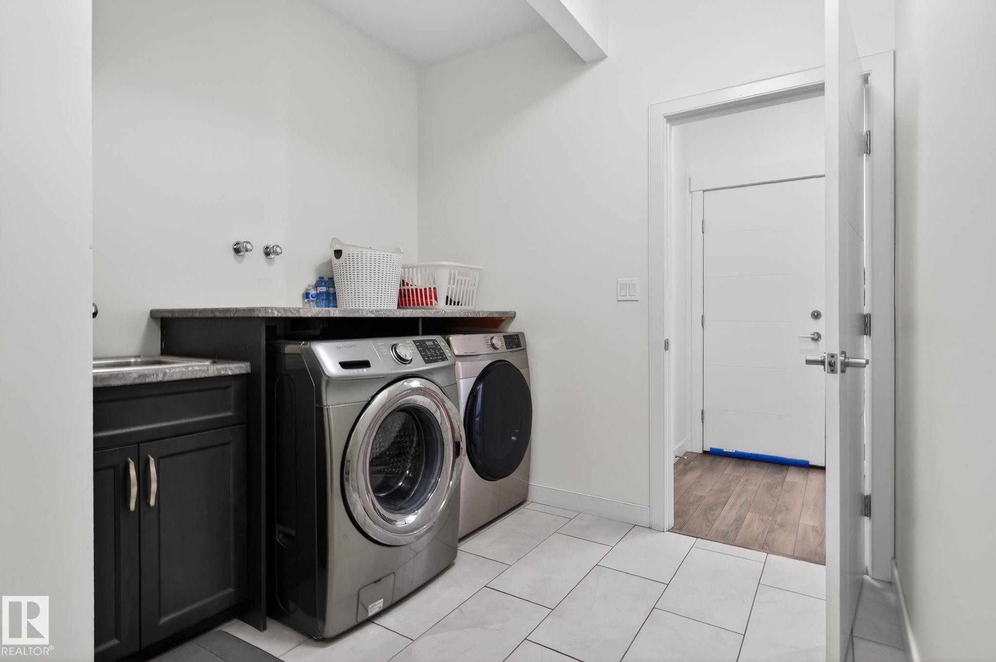 Utility room featuring white tile flooring and white walls - 704 39 Street, Edmonton, AB