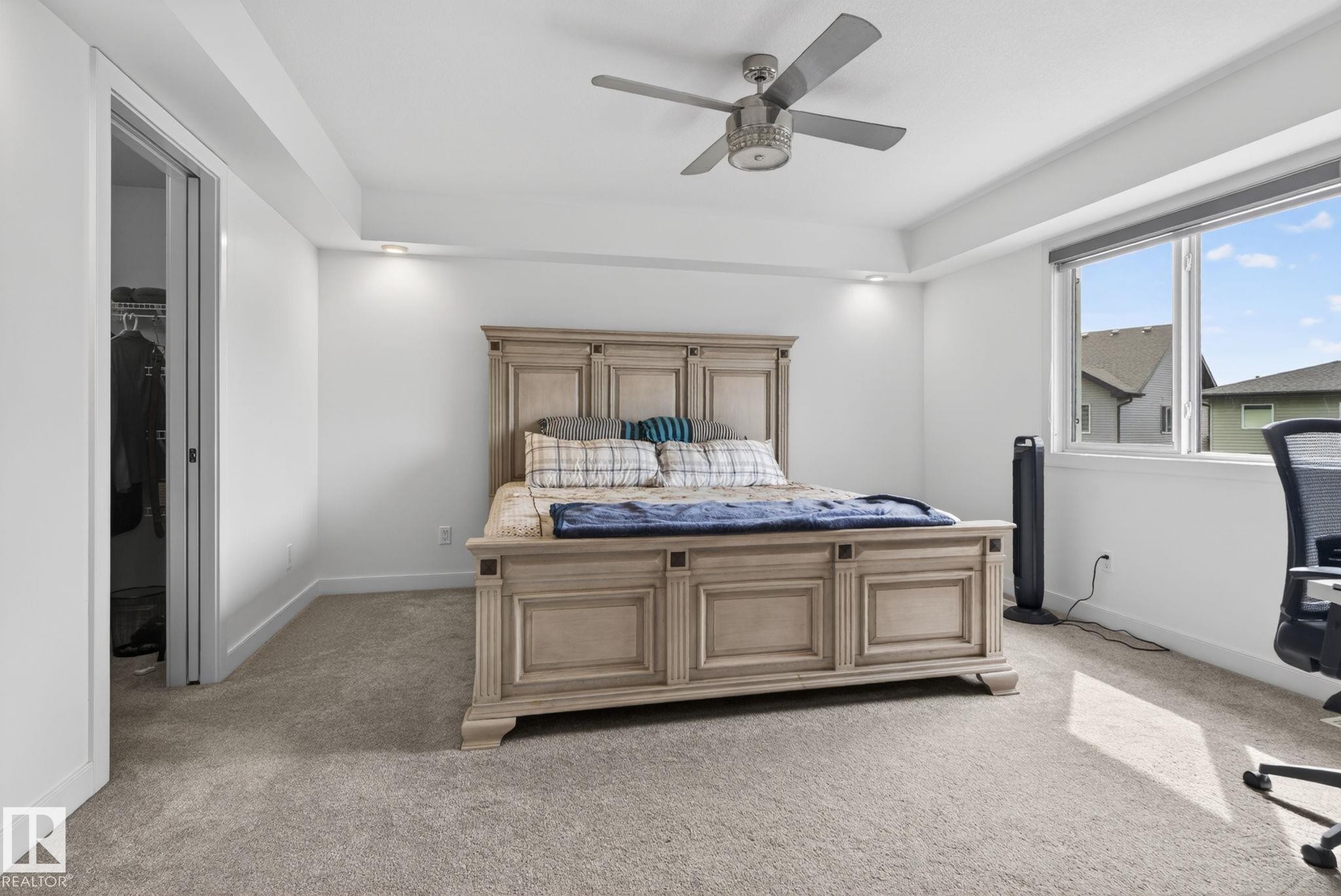 Carpeted interior space featuring a ceiling fan, recessed lighting, and a window with blinds - 704 39 Street, Edmonton, AB