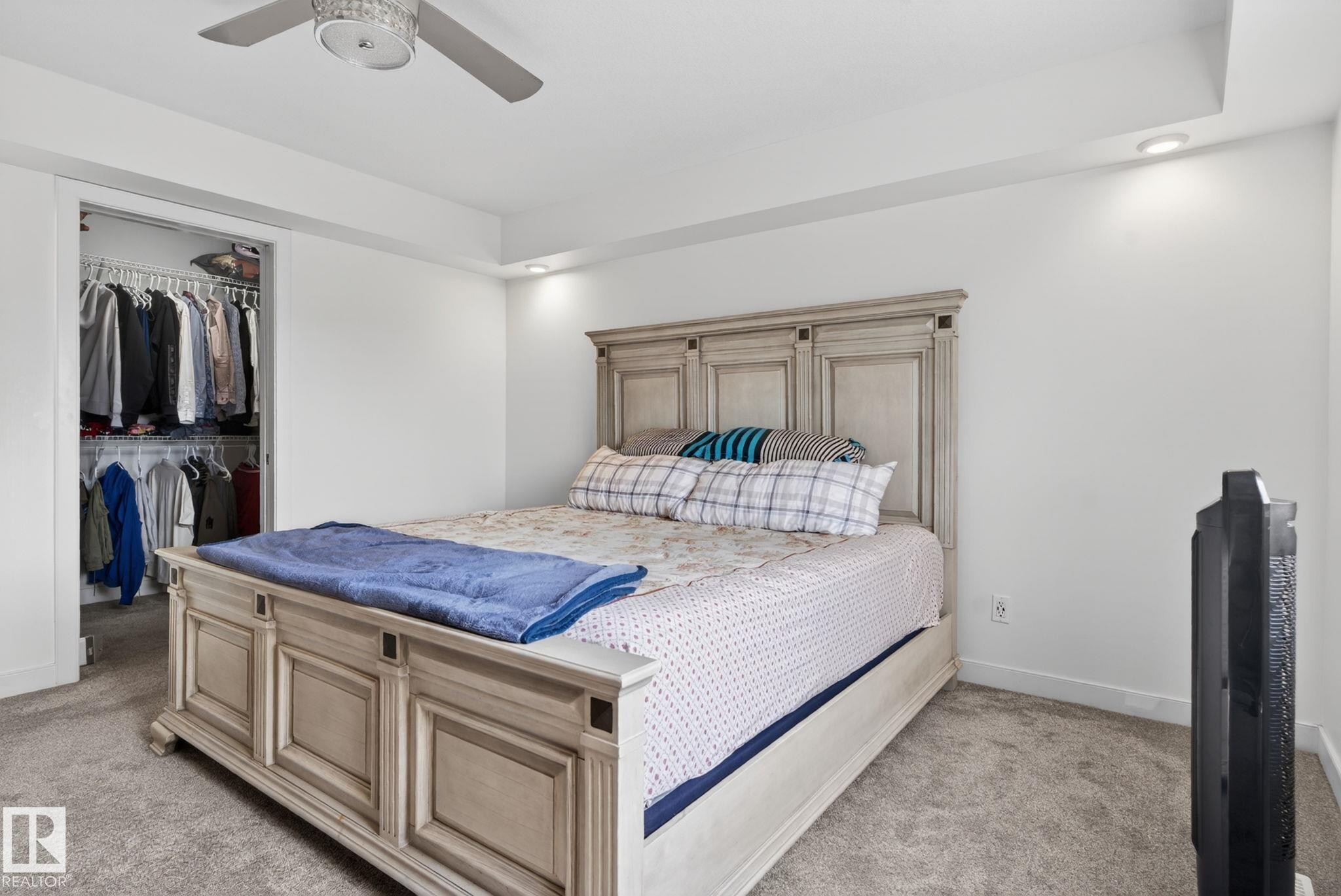 Carpeted bedroom featuring recessed lighting, a ceiling fan, and a walk-in closet with built-in shelving and hanging rods - 704 39 Street, Edmonton, AB