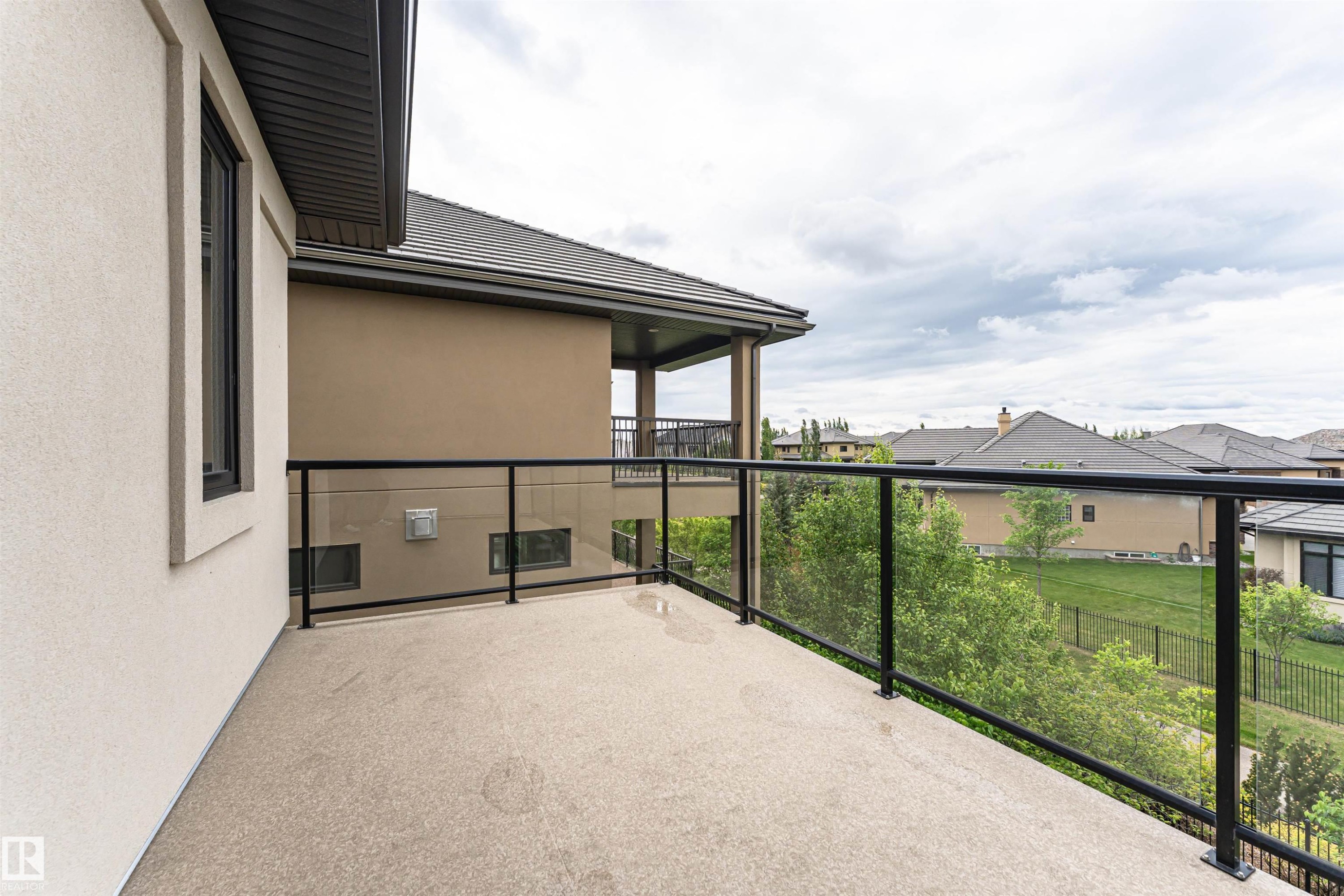 Exterior balcony featuring a glass railing system and a textured surface - 3310 Watson Bay, Edmonton, AB