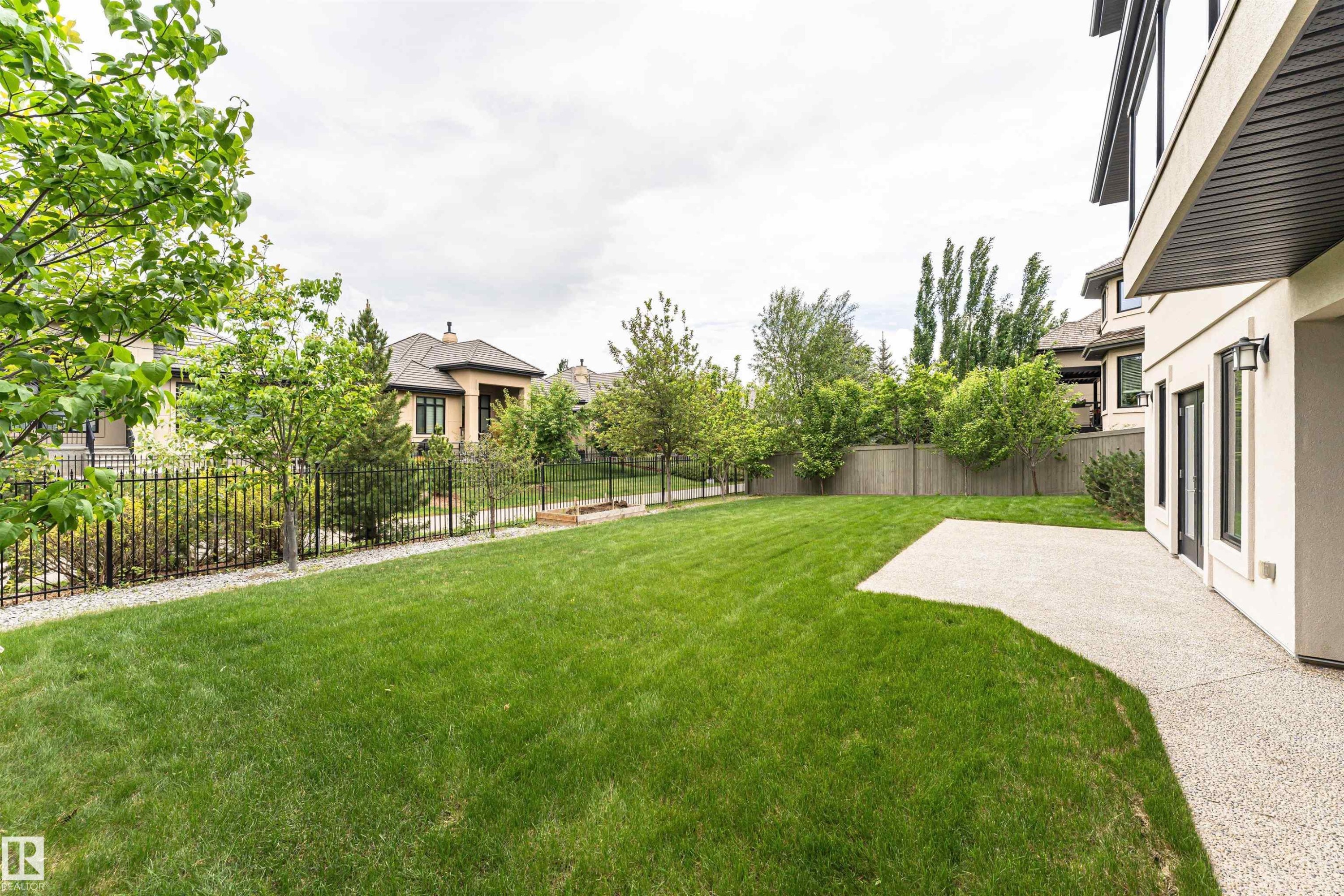 Expansive lawn area with a concrete patio - 3310 Watson Bay, Edmonton, AB