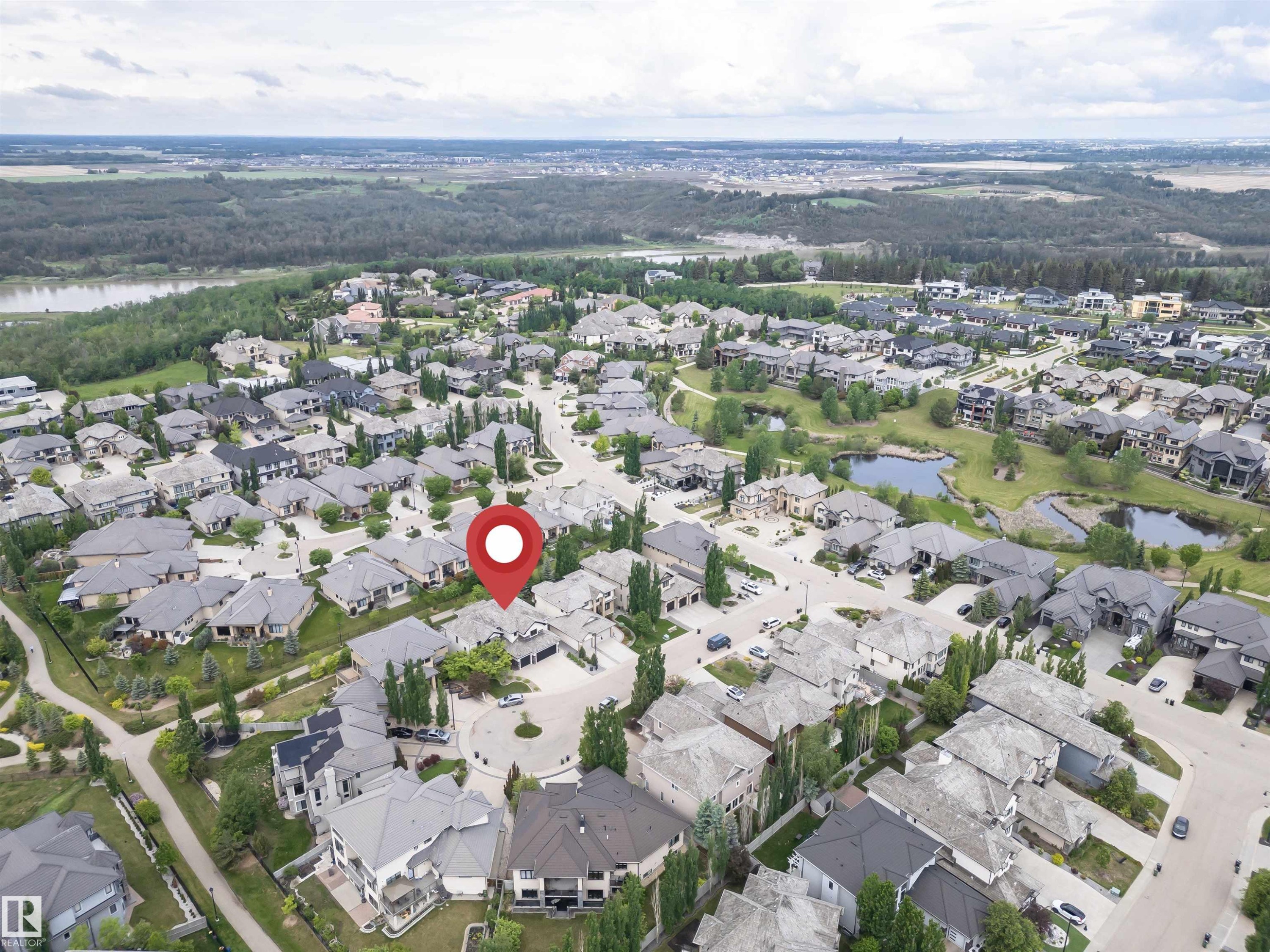Aerial perspective of a residential neighborhood featuring established homes, paved roads, and mature landscaping - 3310 Watson Bay, Edmonton, AB