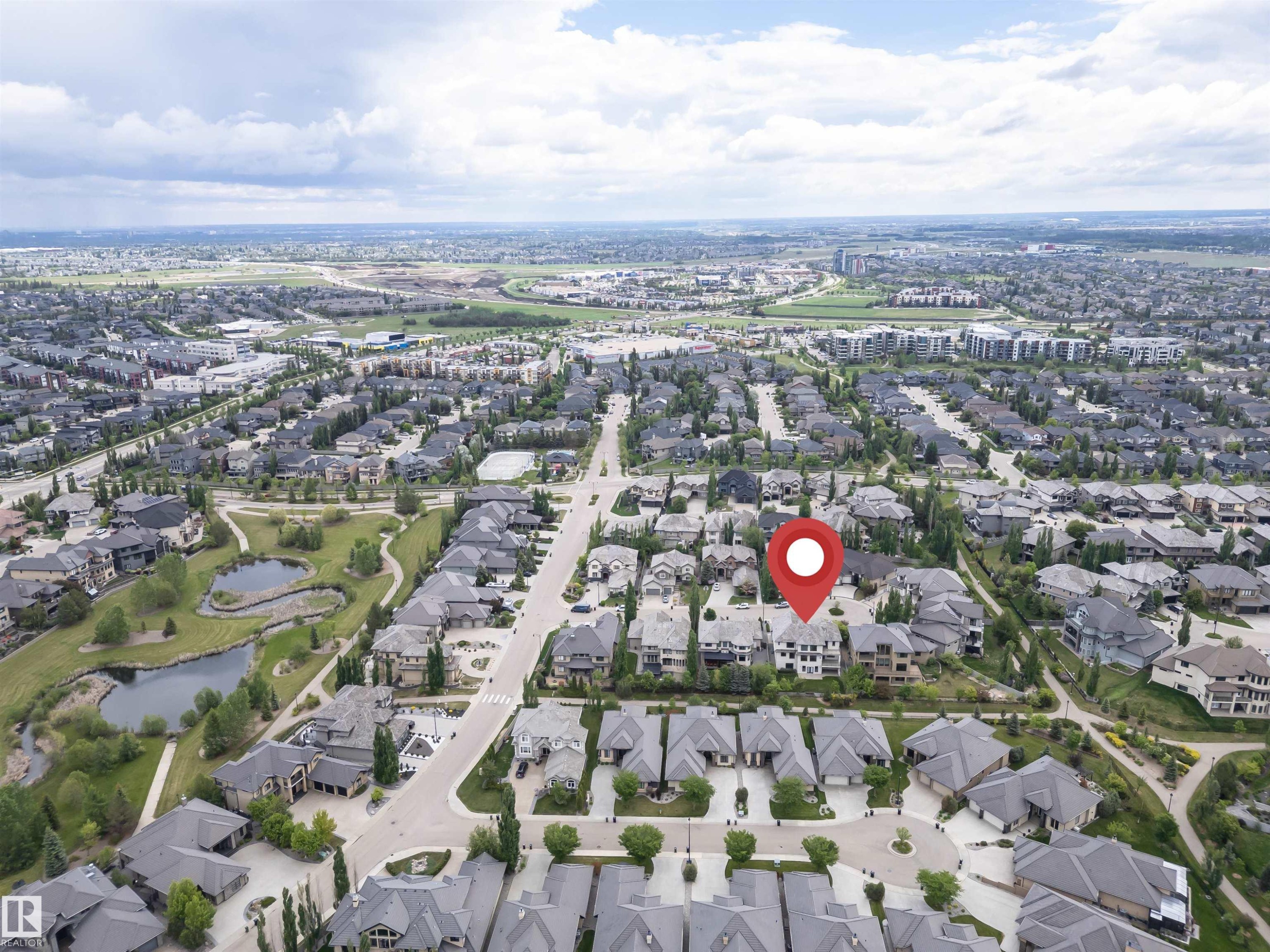 Aerial view of a residential neighborhood featuring detached homes with grey roofs and mature landscaping - 3310 Watson Bay, Edmonton, AB