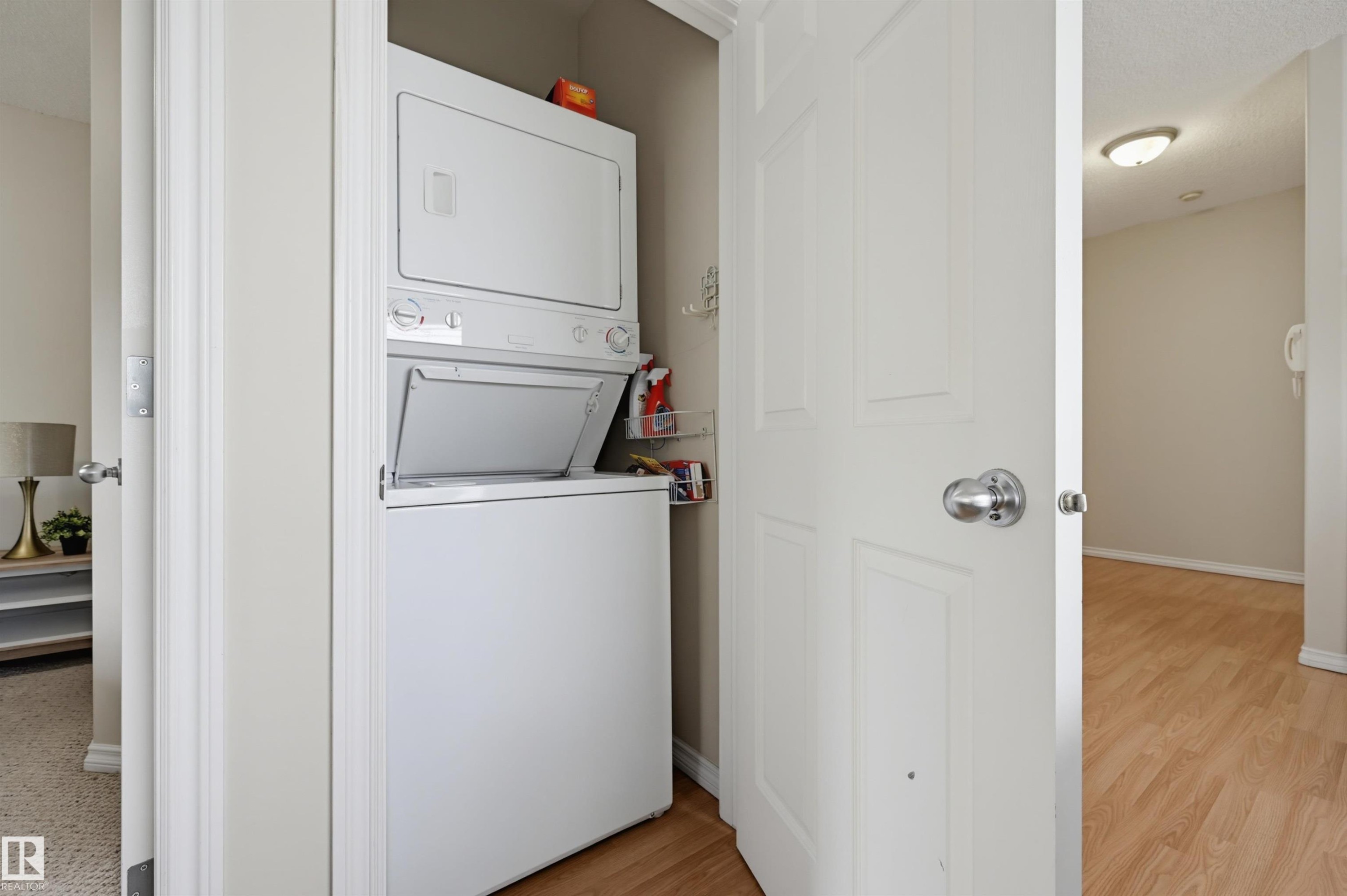 Dedicated laundry closet with a stacked washer and dryer unit - 203 10719 80 Avenue, Edmonton, AB