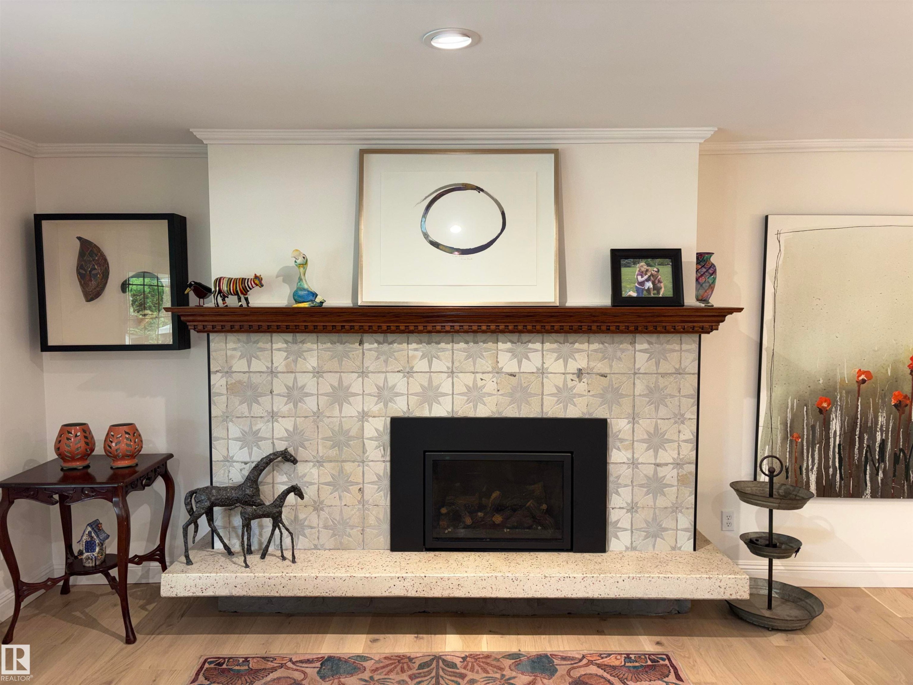 Fireplace featuring a patterned tile surround, a dark wood mantel, and a built-in firebox - 14016 85 Avenue Nw, Edmonton, AB - Indoor Photo Showing Living Room With Fireplace