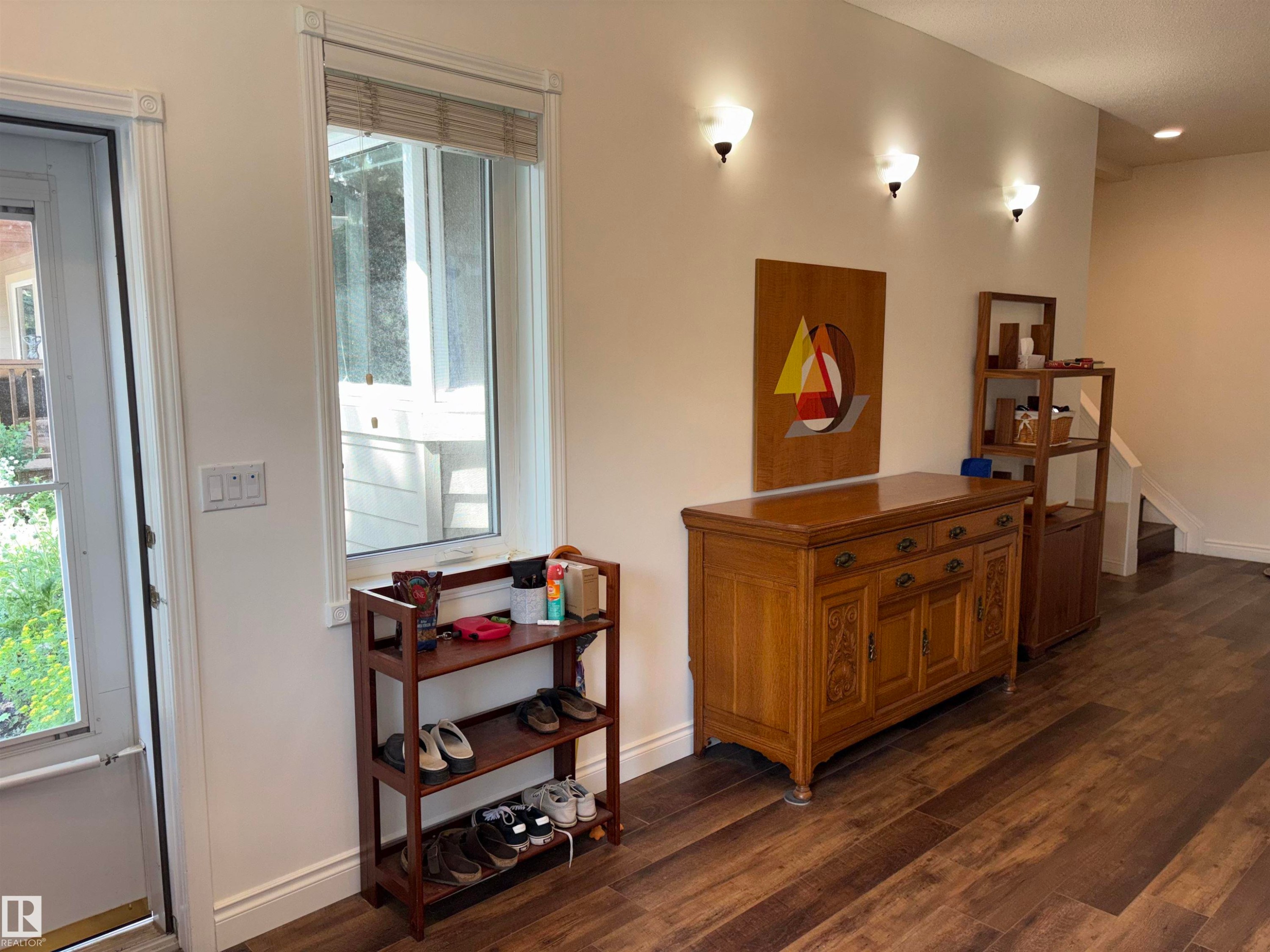 Foyer featuring a frosted glass entry door, wood-finish flooring, and white wall sconces - 14016 85 Avenue Nw, Edmonton, AB - Indoor Photo Showing Other Room
