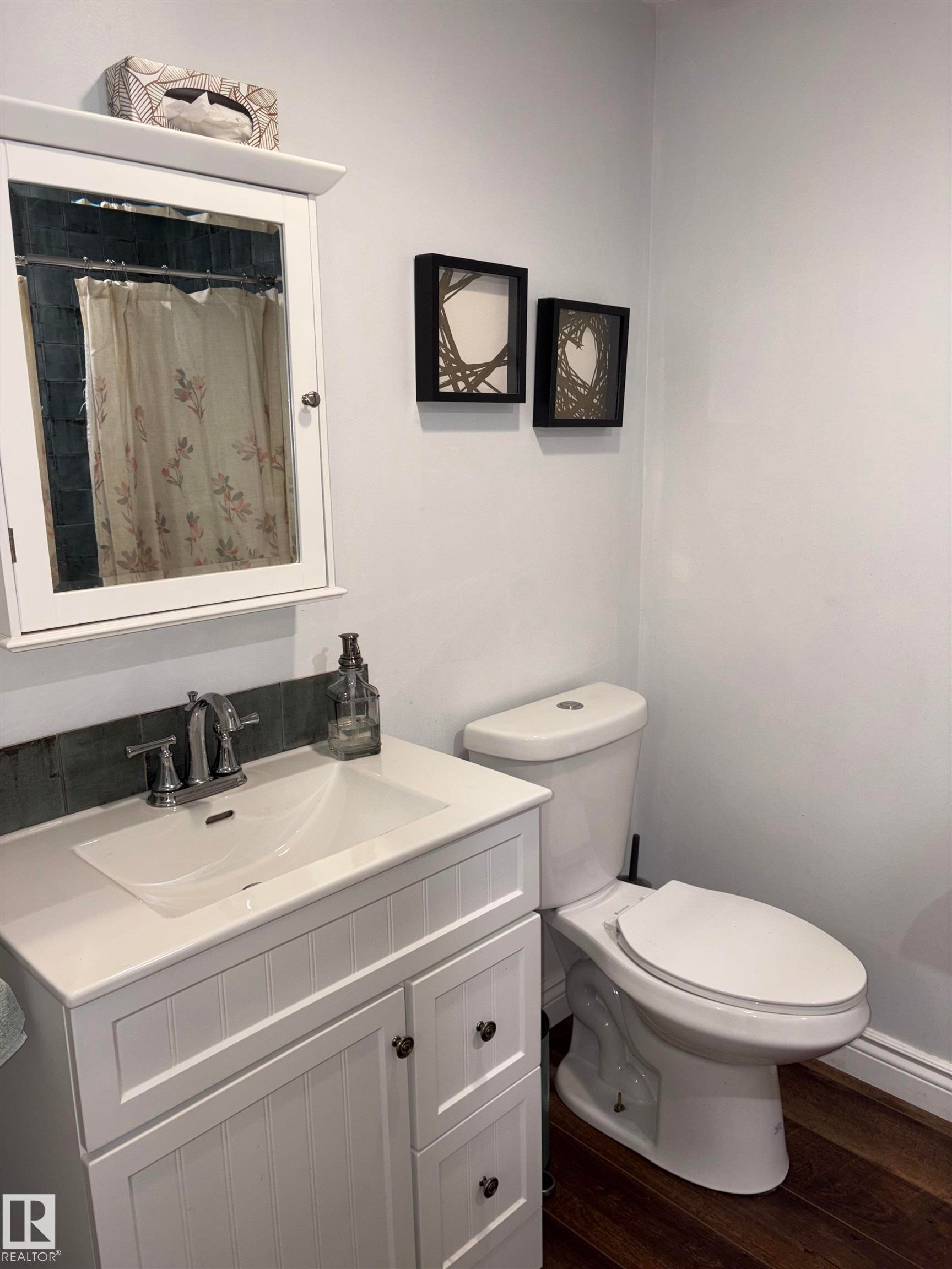 White shaker-style vanity with integrated sink, chrome faucet, and coordinating medicine cabinet - 14016 85 Avenue Nw, Edmonton, AB - Indoor Photo Showing Bathroom