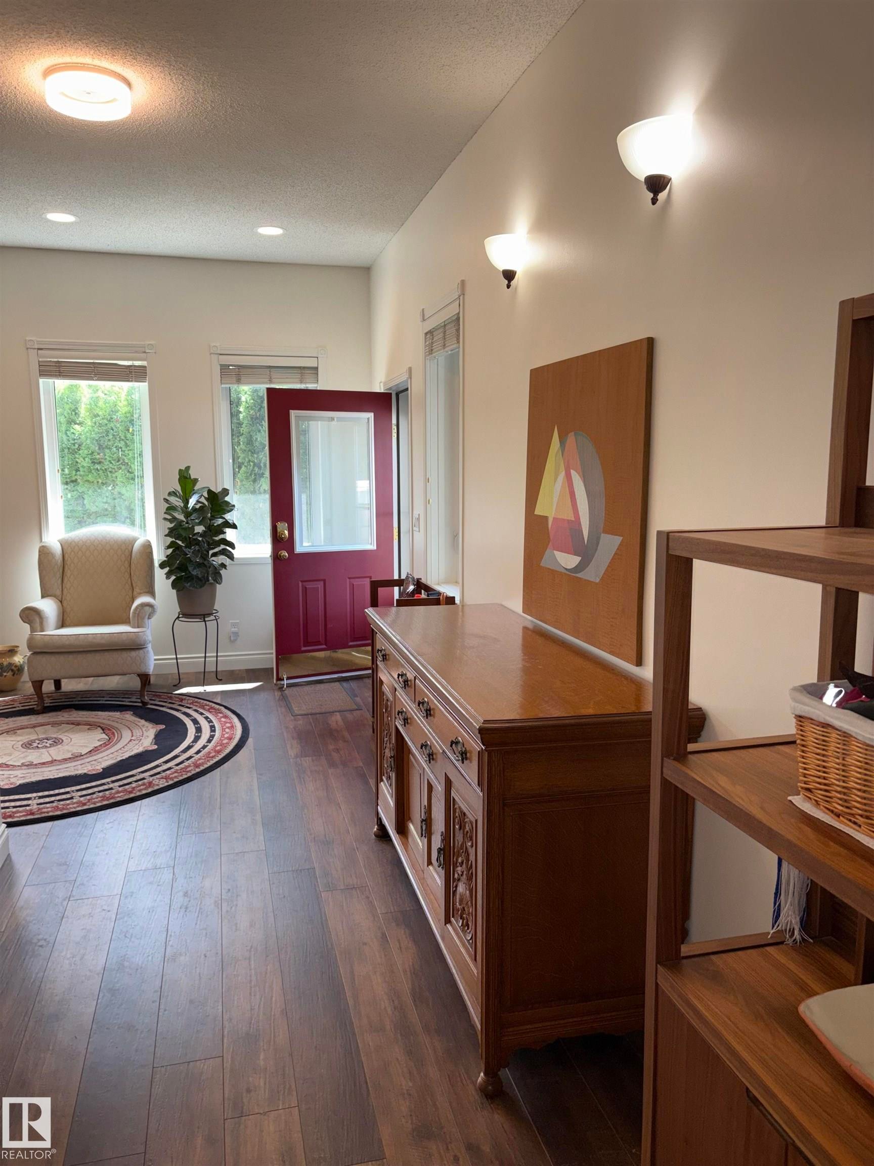 Entryway featuring dark wood-finish flooring, white walls, and recessed lighting - 14016 85 Avenue Nw, Edmonton, AB - Indoor