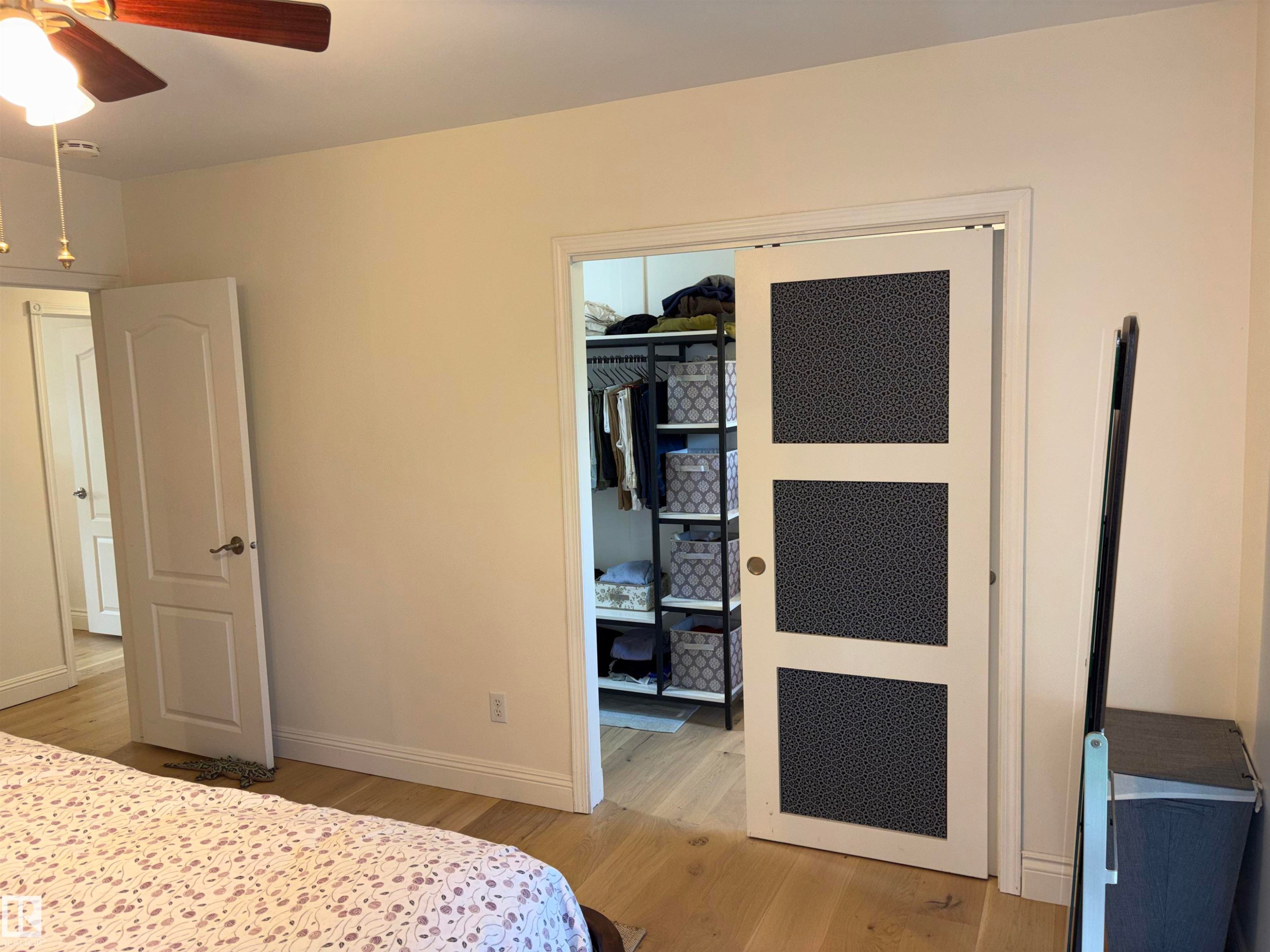 Light wood-finish flooring with white baseboards throughout - 14016 85 Avenue Nw, Edmonton, AB - Indoor Photo Showing Bedroom