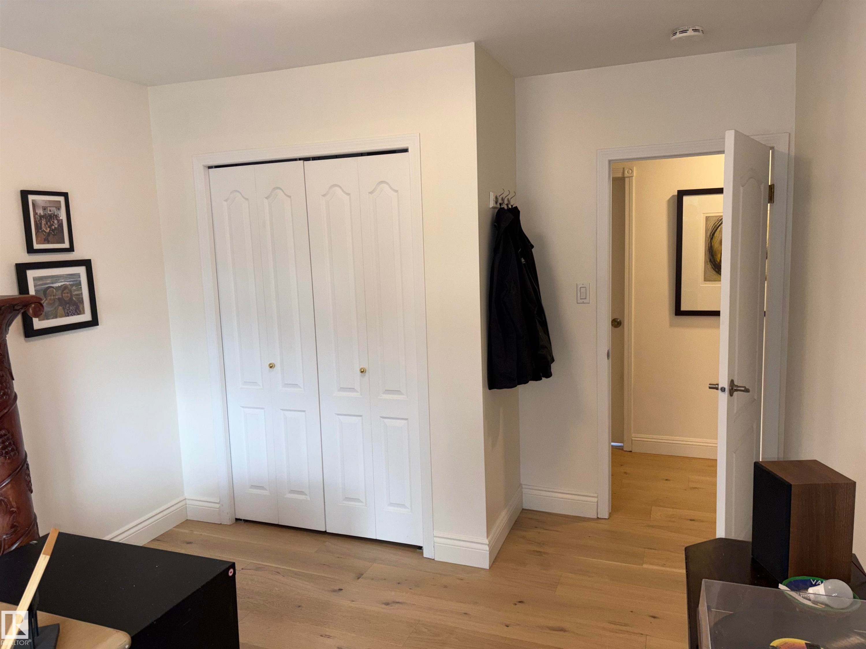 Room featuring light wood-finish flooring, white walls, and bright white baseboards - 14016 85 Avenue Nw, Edmonton, AB - Indoor