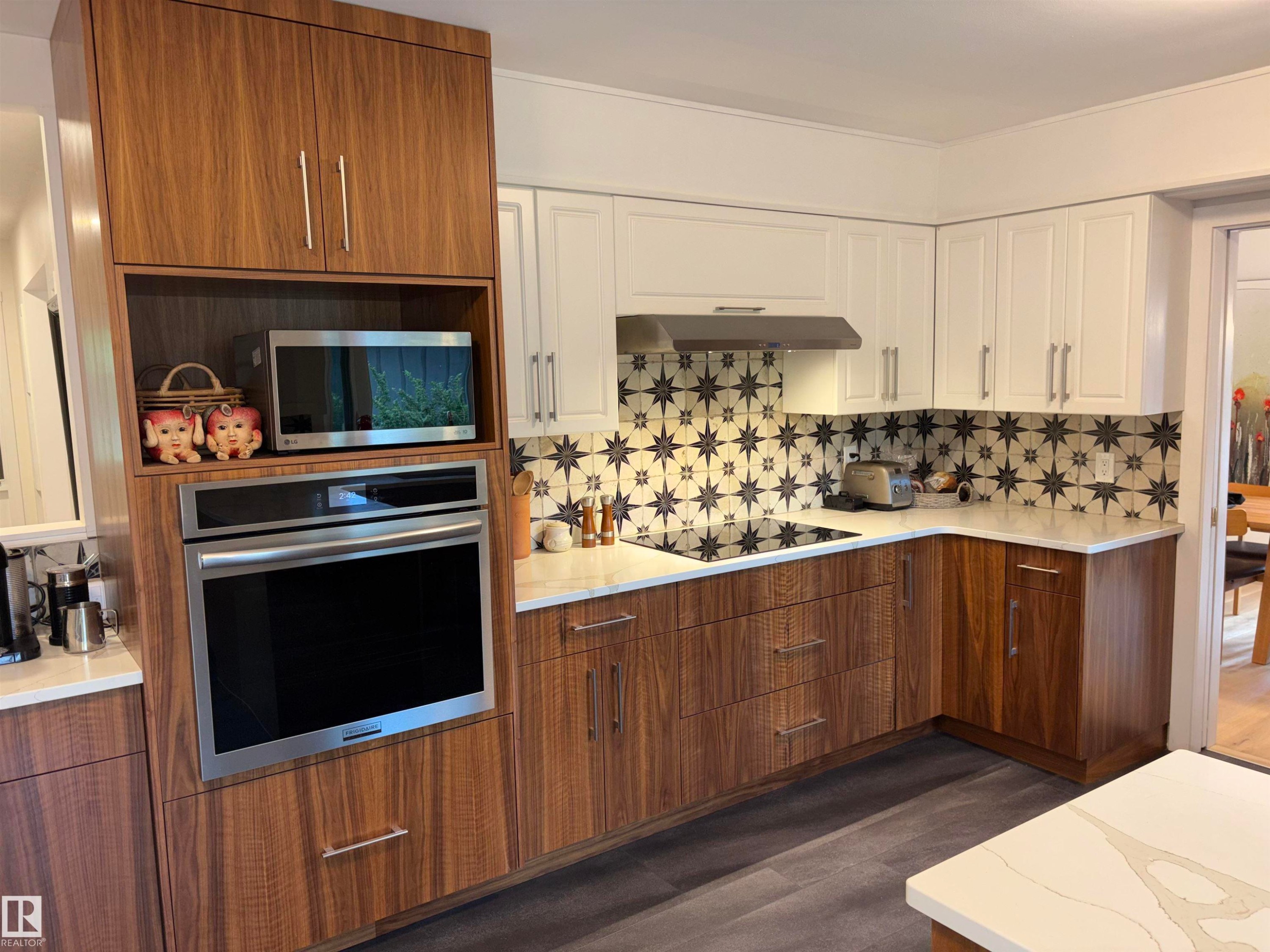 Modern kitchen featuring two-tone cabinetry, a built-in stainless steel oven, and a built-in microwave - 14016 85 Avenue Nw, Edmonton, AB - Indoor Photo Showing Kitchen
