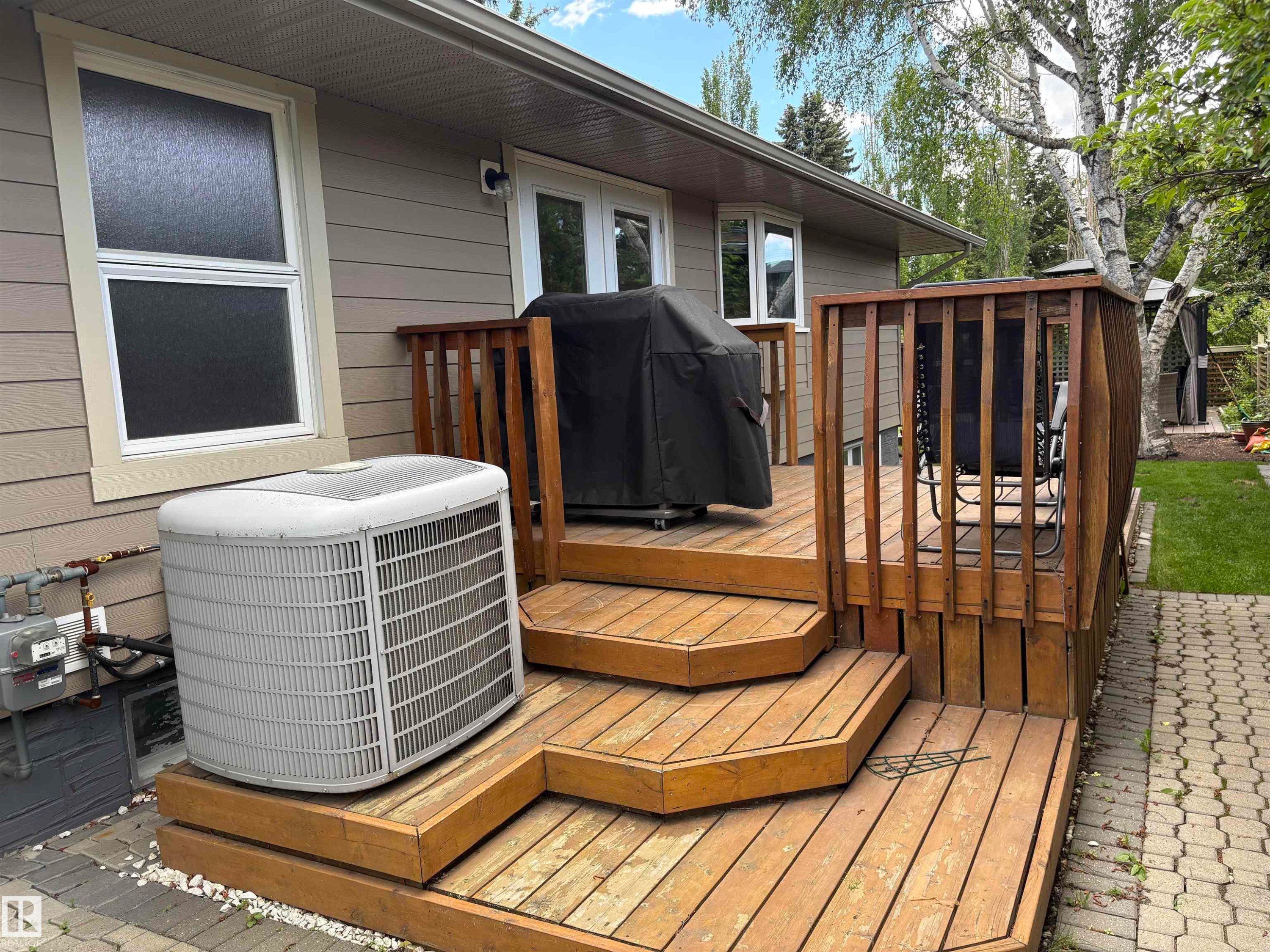 Multi-level wood deck with integrated steps, natural wood railings, and direct access to the interior via double glass doors - 14016 85 Avenue Nw, Edmonton, AB - Outdoor With Deck Patio Veranda With Exterior