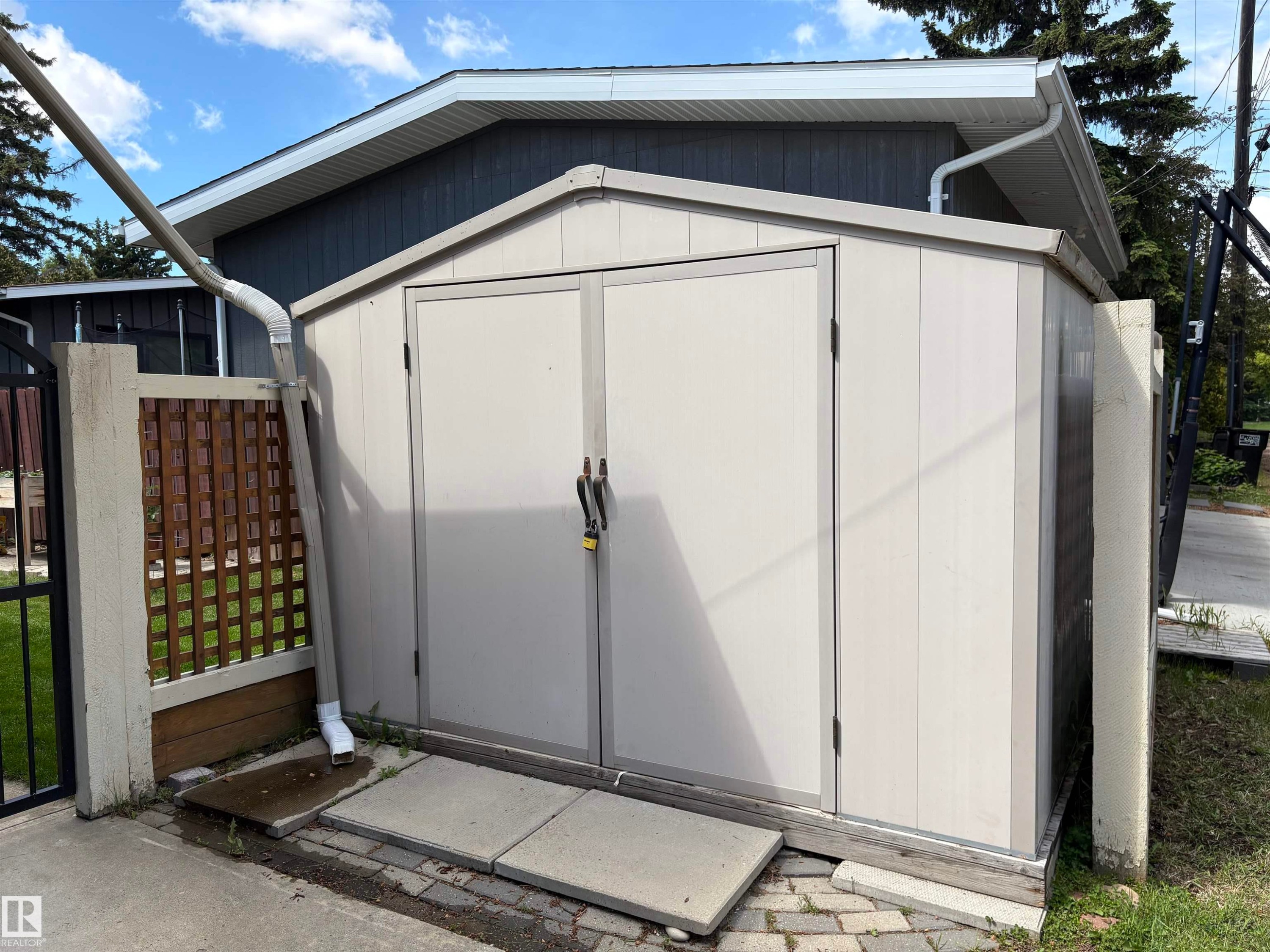 Freestanding storage shed with double doors and a pitched roof - 14016 85 Avenue Nw, Edmonton, AB - Outdoor With Exterior