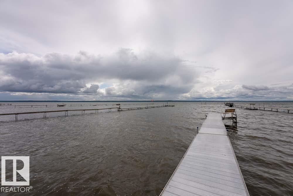 Expansive water frontage featuring multiple private dock structures - A38 Bernice Ave, Rural Leduc County, AB