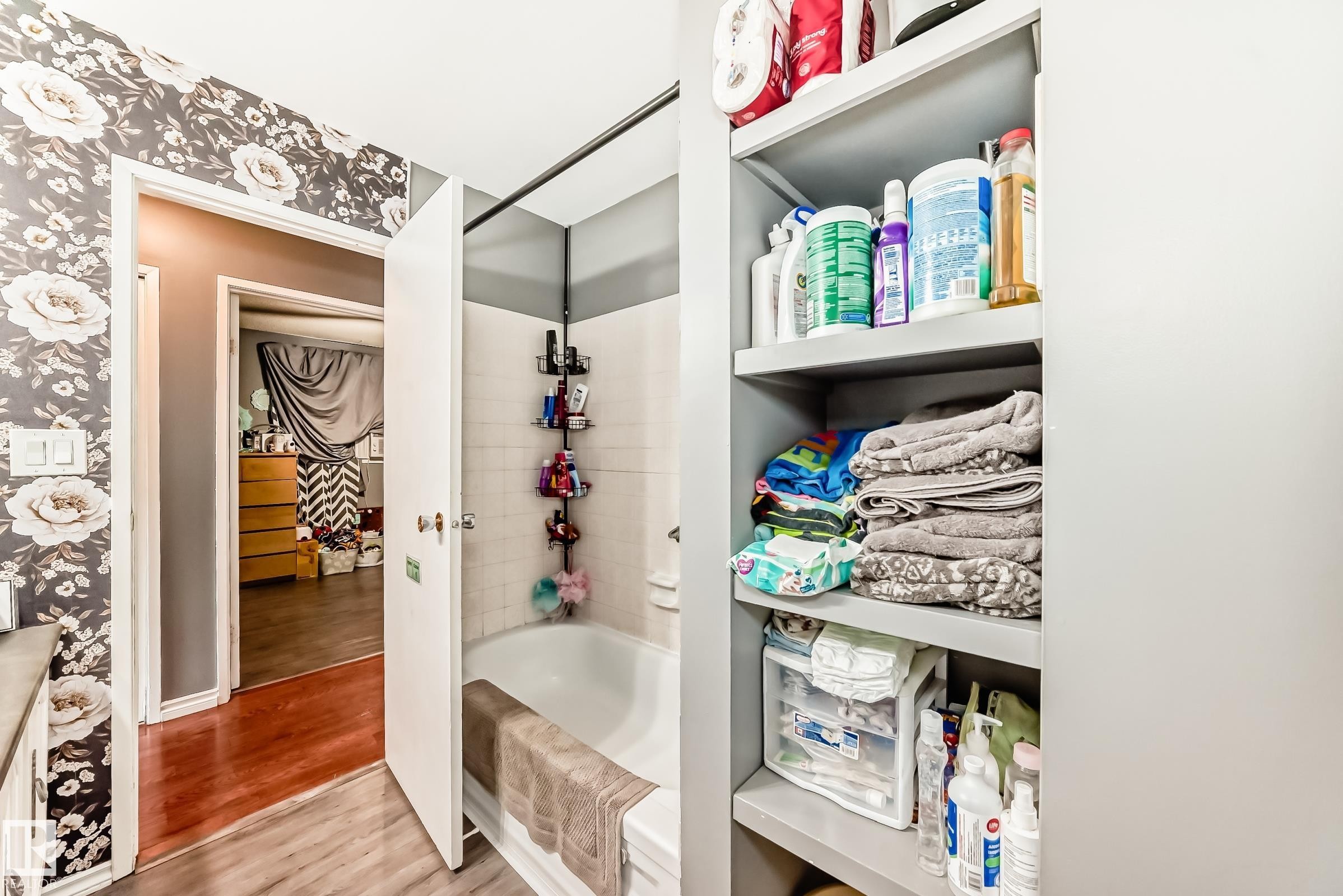 Bathroom featuring a white tub, white subway tile surround, and a coordinating shower rod - 5106 19 Avenue, Edmonton, AB