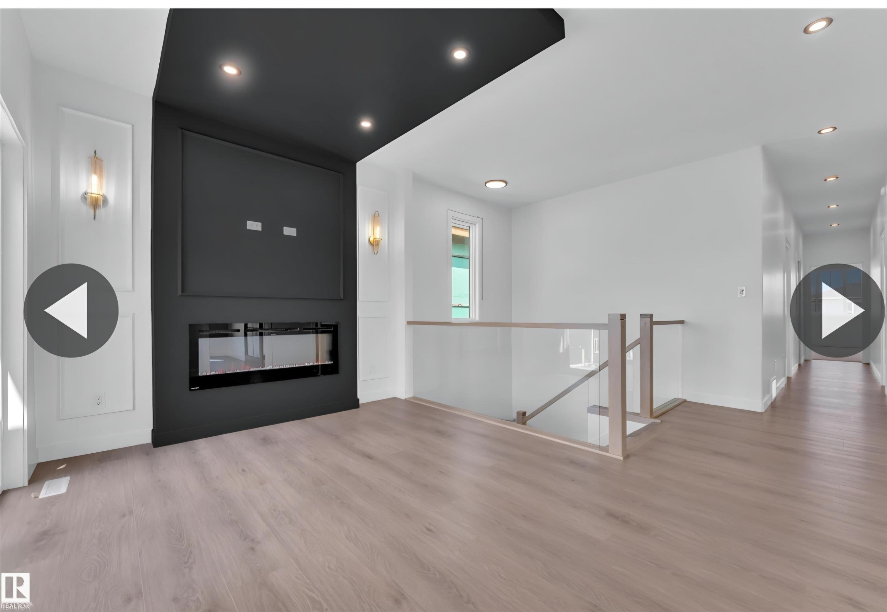 Modern linear fireplace framed by a dark accent wall with recessed lighting - 13140 187 Avenue, Edmonton, AB