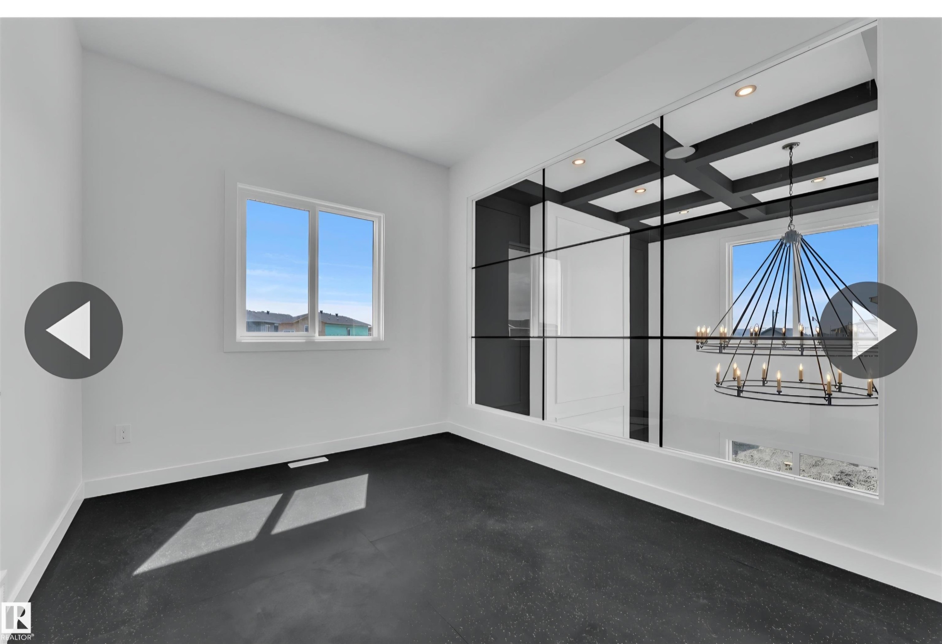 Bright room featuring dark flooring, white walls, and a large window - 13140 187 Avenue, Edmonton, AB