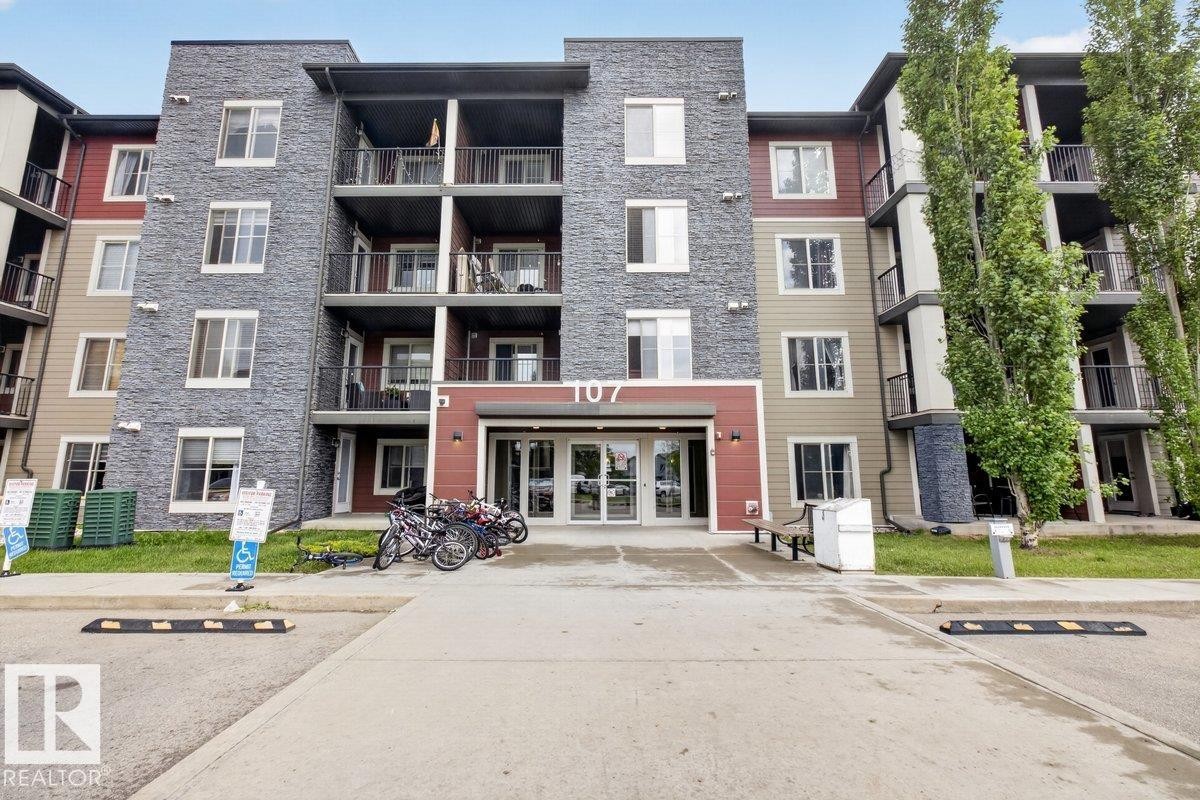 Contemporary multi-story building featuring a stone and siding exterior - 101 107 Watt Common, Edmonton, AB