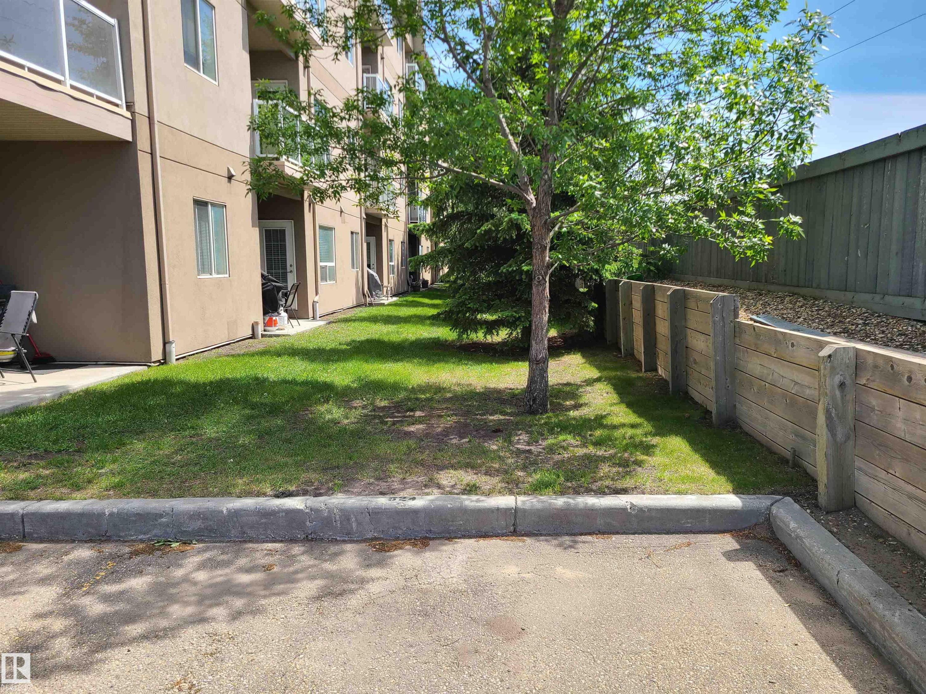 Ground-level patio access from the building exterior - 116 5005 165 Avenue, Edmonton, AB