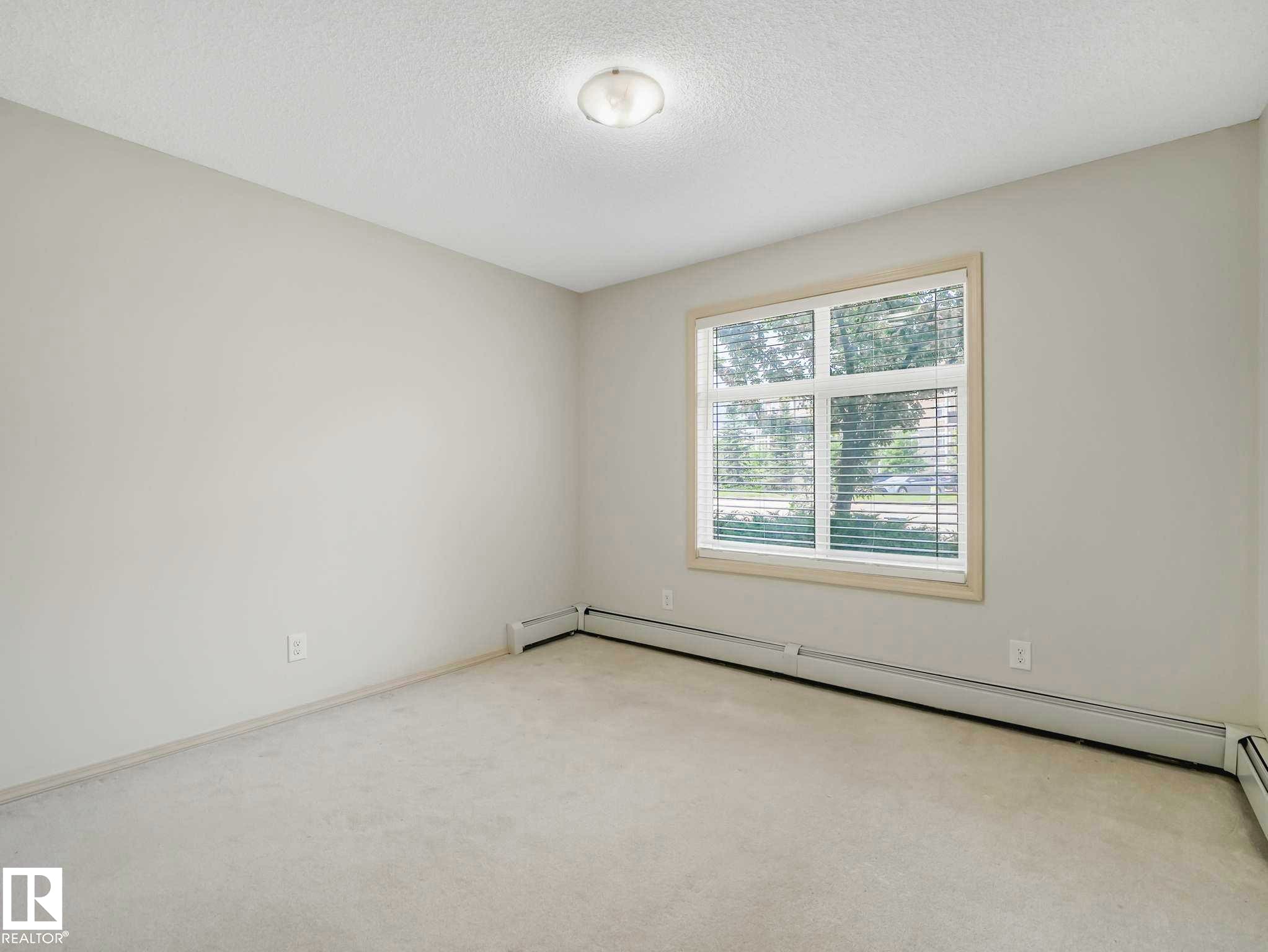 Neutral-toned wall paint and carpeting throughout - 117 6070 Schonsee Way, Edmonton, AB